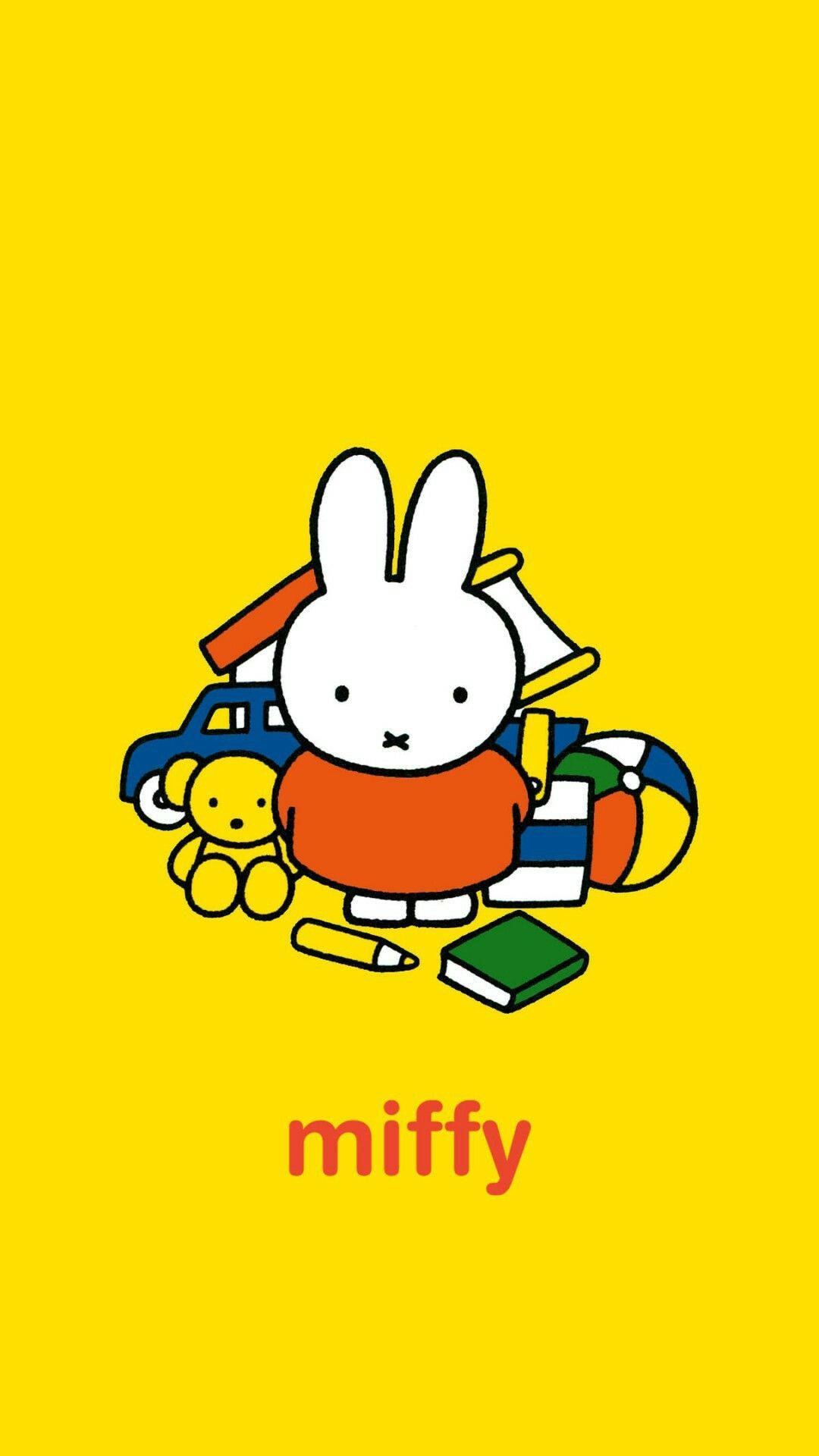 Miffy兔子在黃色背景上被玩具包圍。