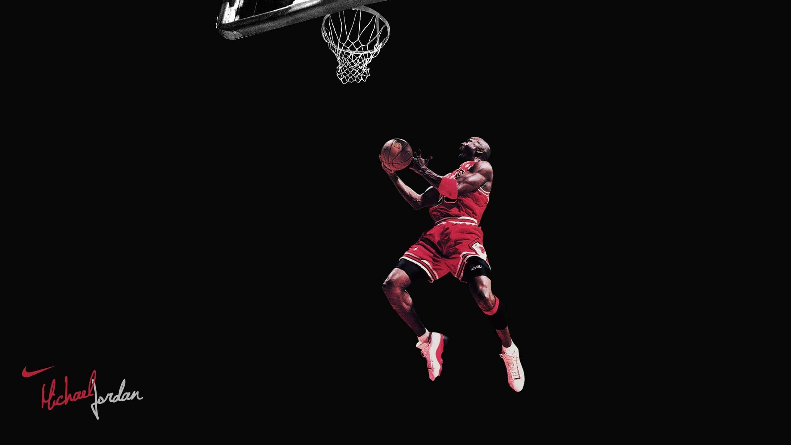 Jordan 桌布 壁紙 — 米高佐敦身穿紅色球衣在空中飛翔，在純黑背景下灌籃。