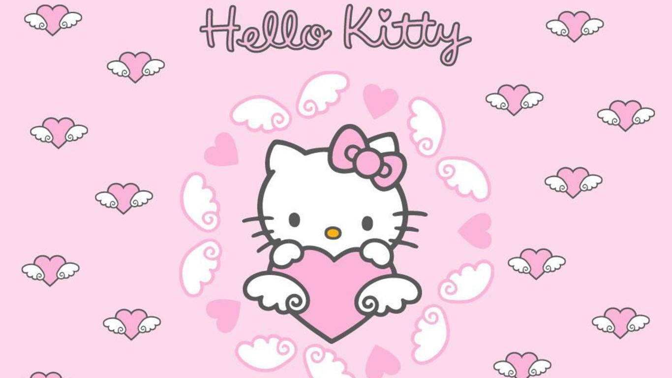 粉紅 Hello Kitty 心形翅膀 壁紙 — Hello Kitty 喺柔和粉紅色背景上，手持一個被漂浮心形同翅膀包圍嘅粉紅色心形。