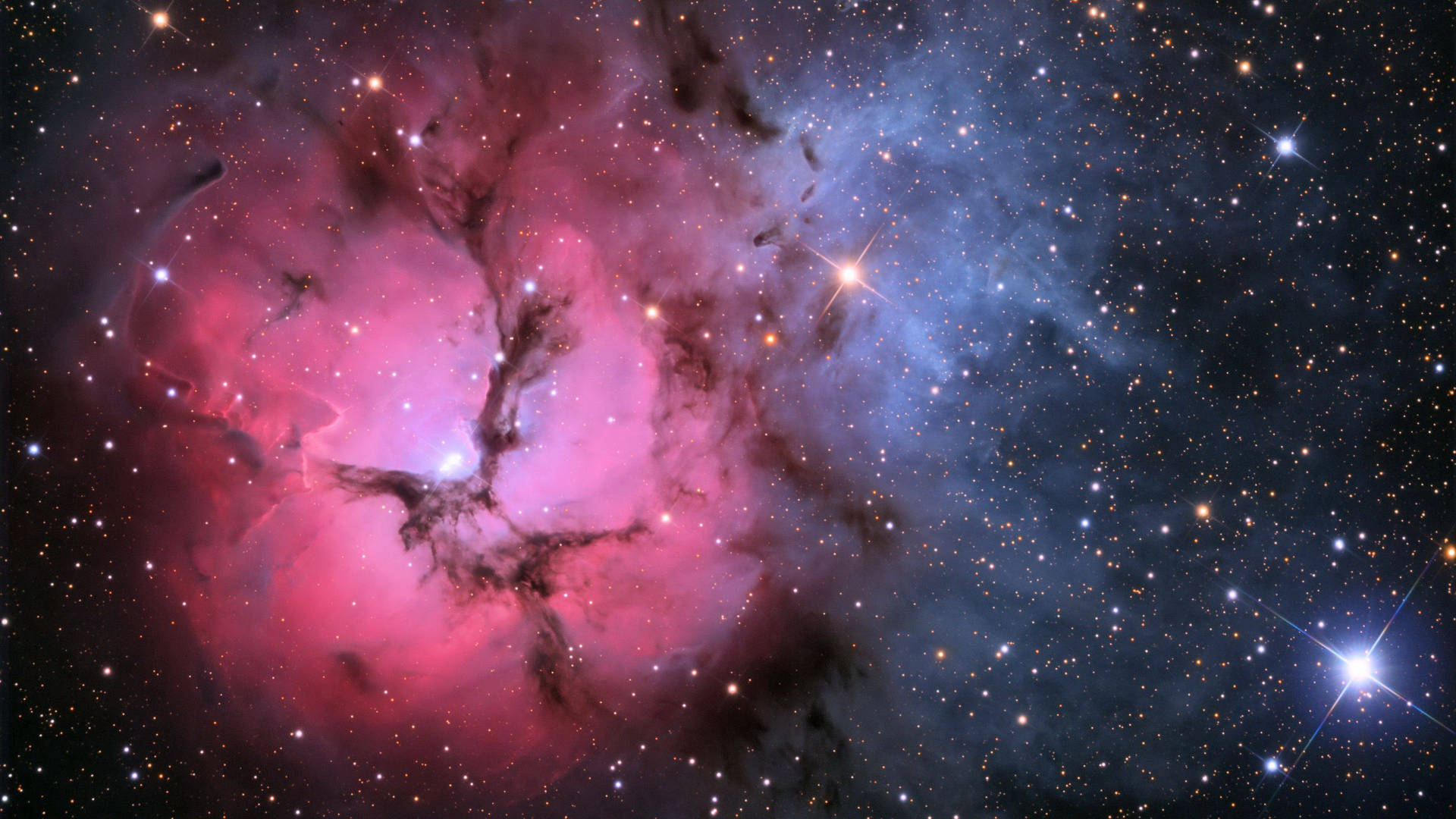 深空中帶有發光星星的充滿活力的粉紅色和藍色星雲。