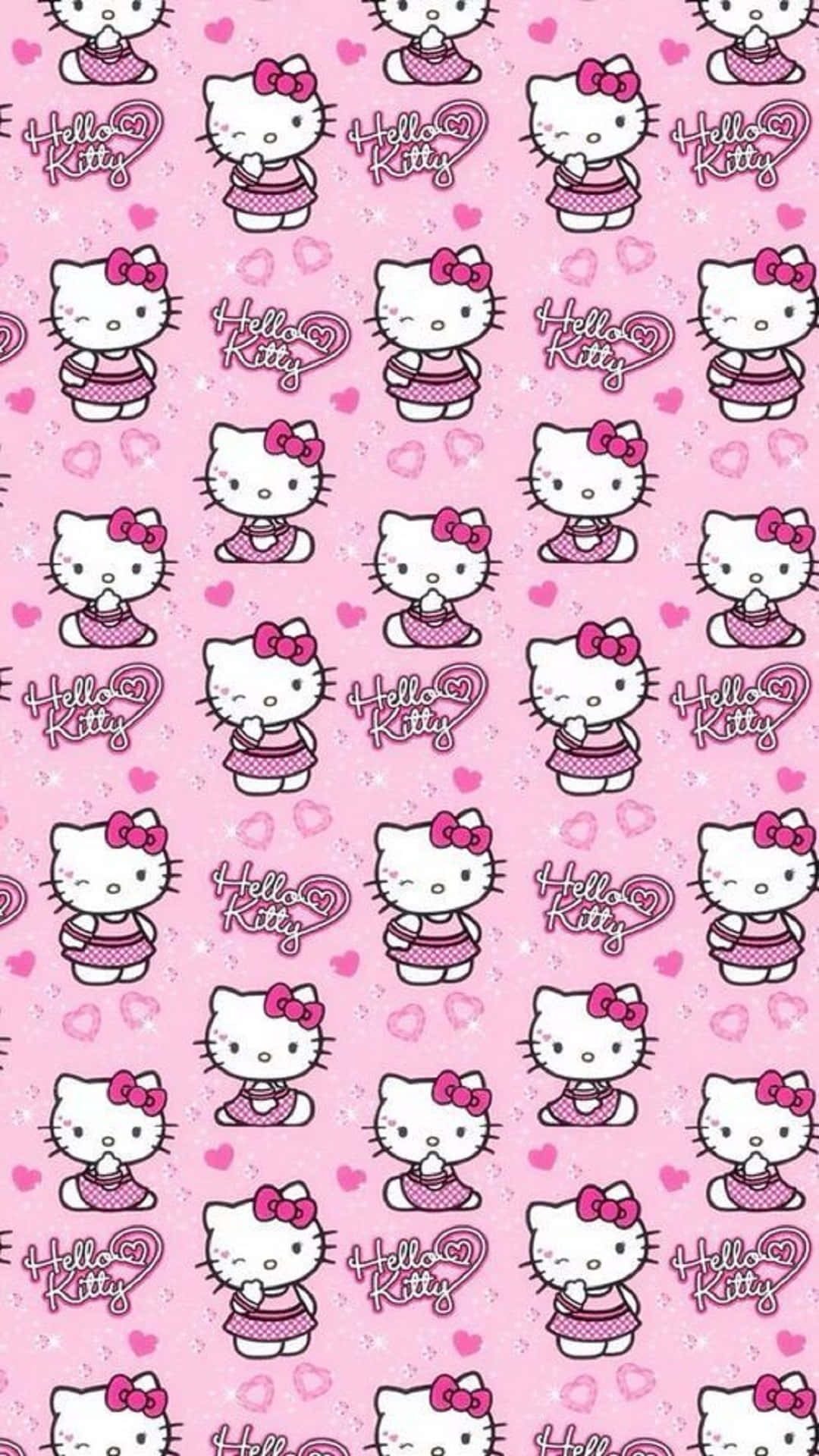 Kawaii Hello Kitty 桌布 壁紙 — 粉紅色牆紙，重複印有身穿波點裙的Hello Kitty角色和心形圖案。