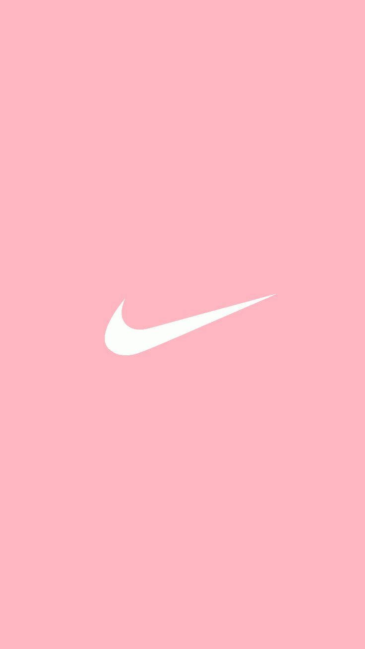 粉紅色背景的勾形標誌 壁紙 — 一個極簡的白色Nike Swoosh標誌，居中放置在純色柔和粉紅色背景上。