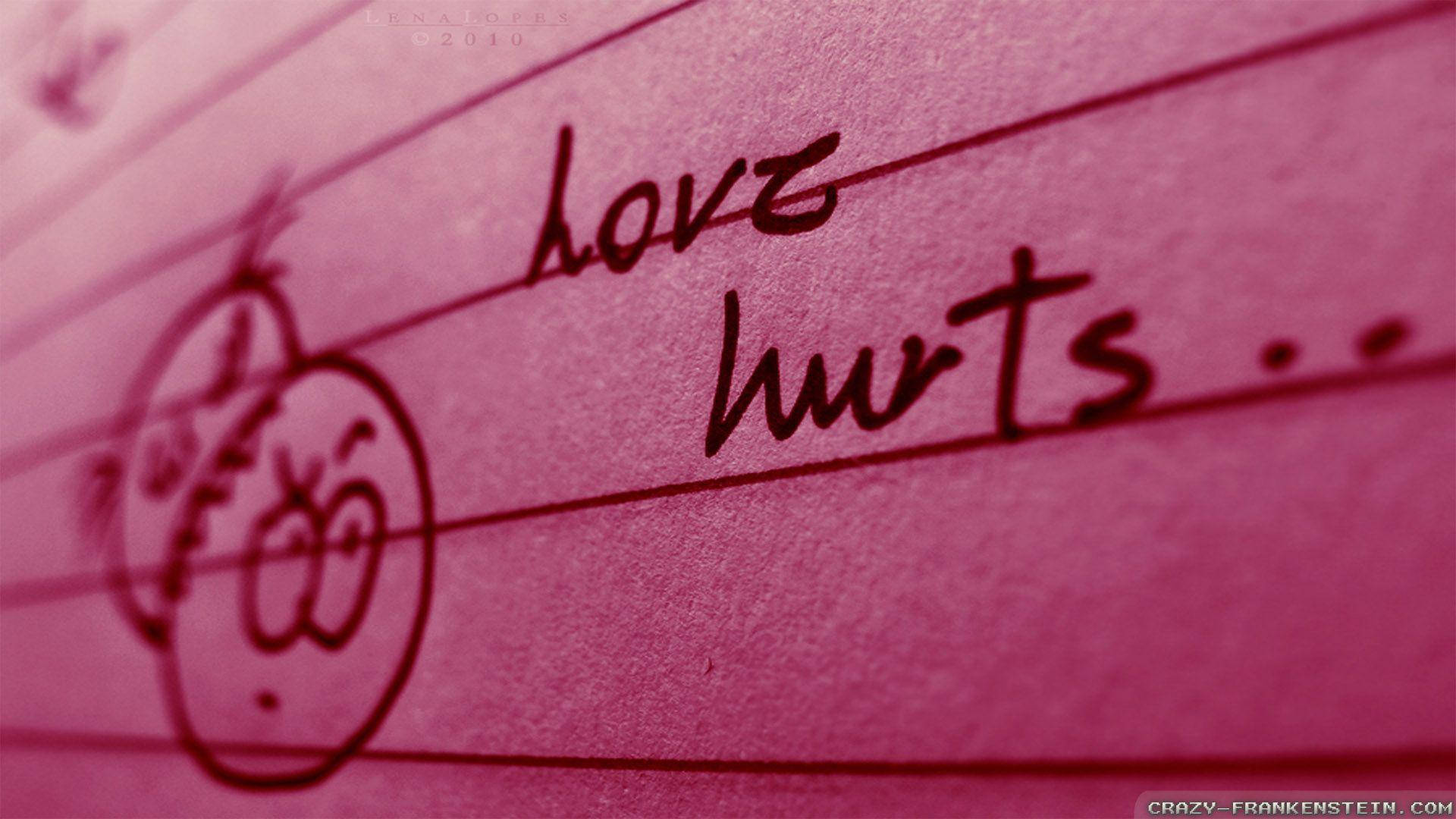 My Love 桌布 壁紙 — 粉紅色間線紙上以深色墨水手寫的「love hurts」字句，旁邊有塗鴉的悲傷臉孔。