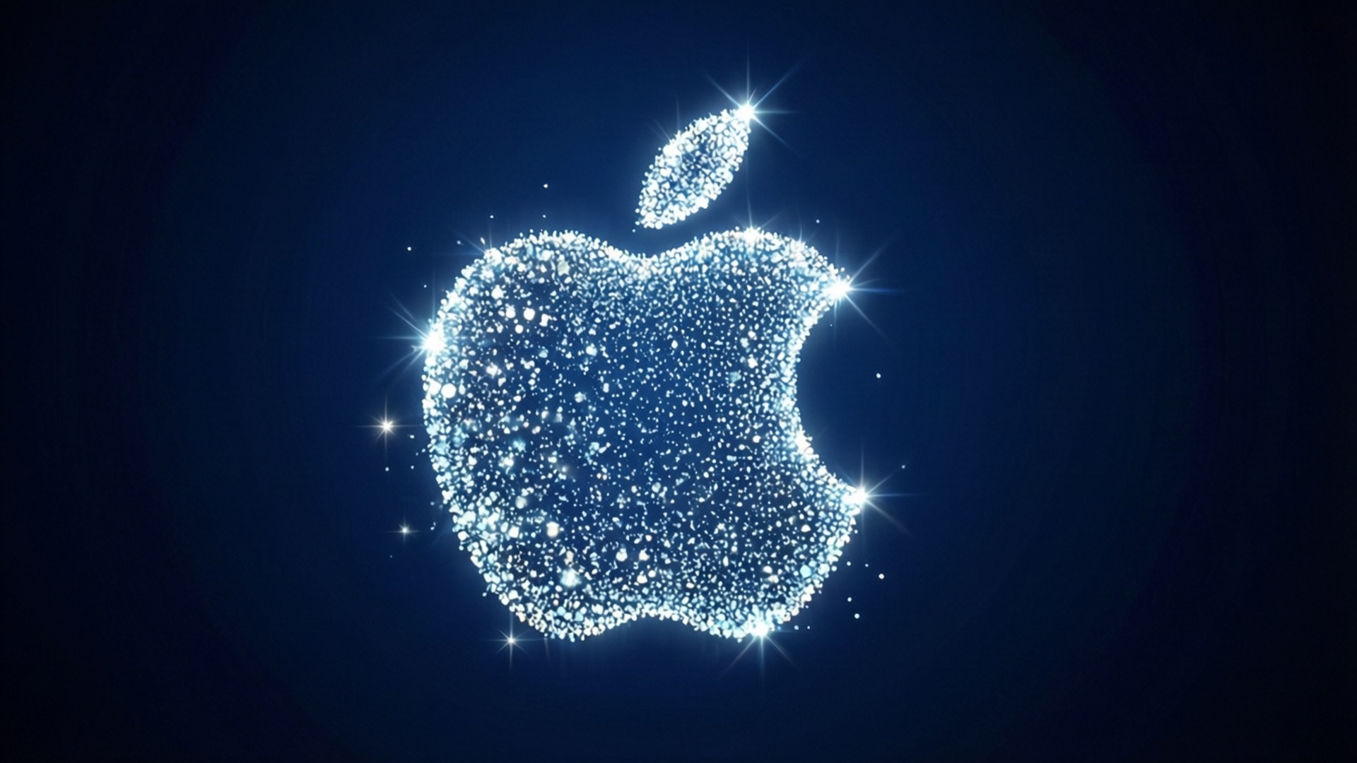 粒子光效標誌 壁紙 — 一個由閃爍粒子組成的發光藍色Apple標誌，在帶有星爆效果的深色背景上閃耀。