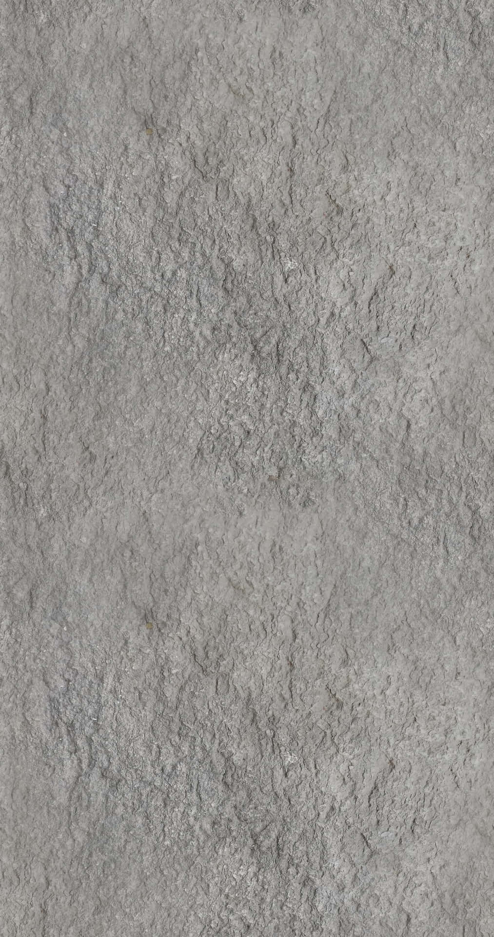 灰色混凝土紋理壁紙，具有微妙的變化和粗糙的表面細節。