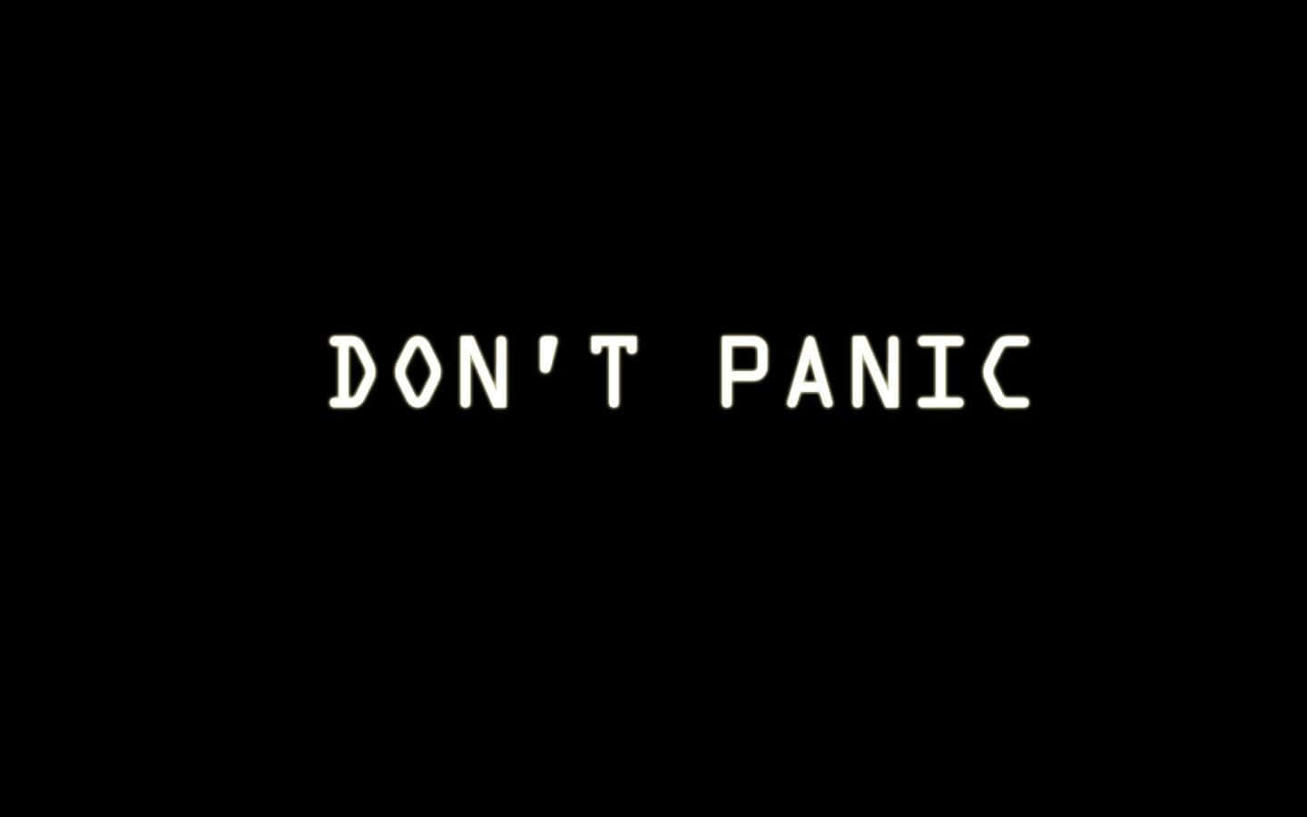 Simple Black 桌布 壁紙 — 粗體白色文字寫著「DON'T PANIC」，居中在純黑色背景上。