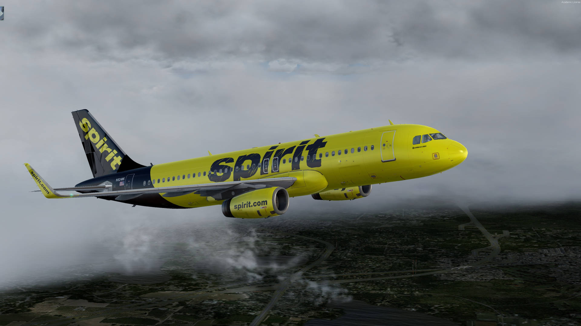 一架黃色精神飛機在雲層和陸地上空飛行。