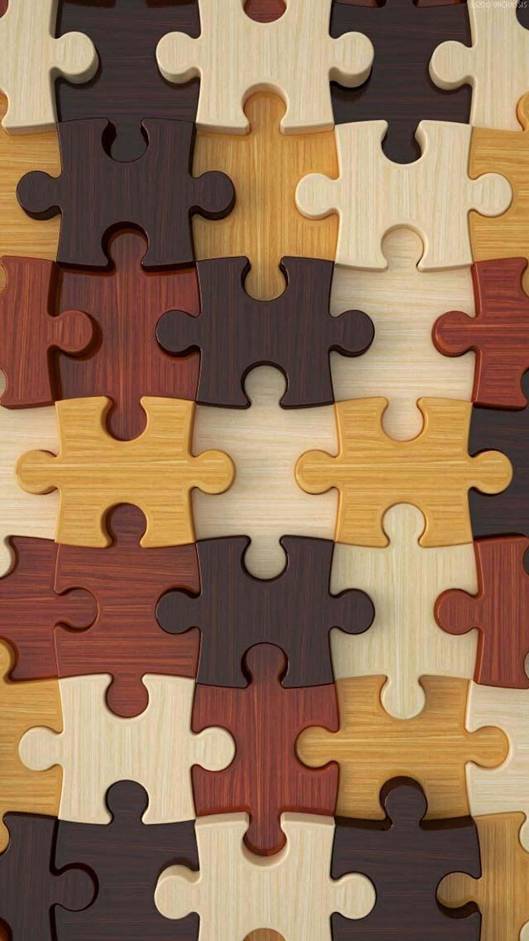 精緻拼圖的迷人近照 壁紙 — 淺棕色和深棕色暖色調中相互鎖定的木製拼圖塊的特寫。