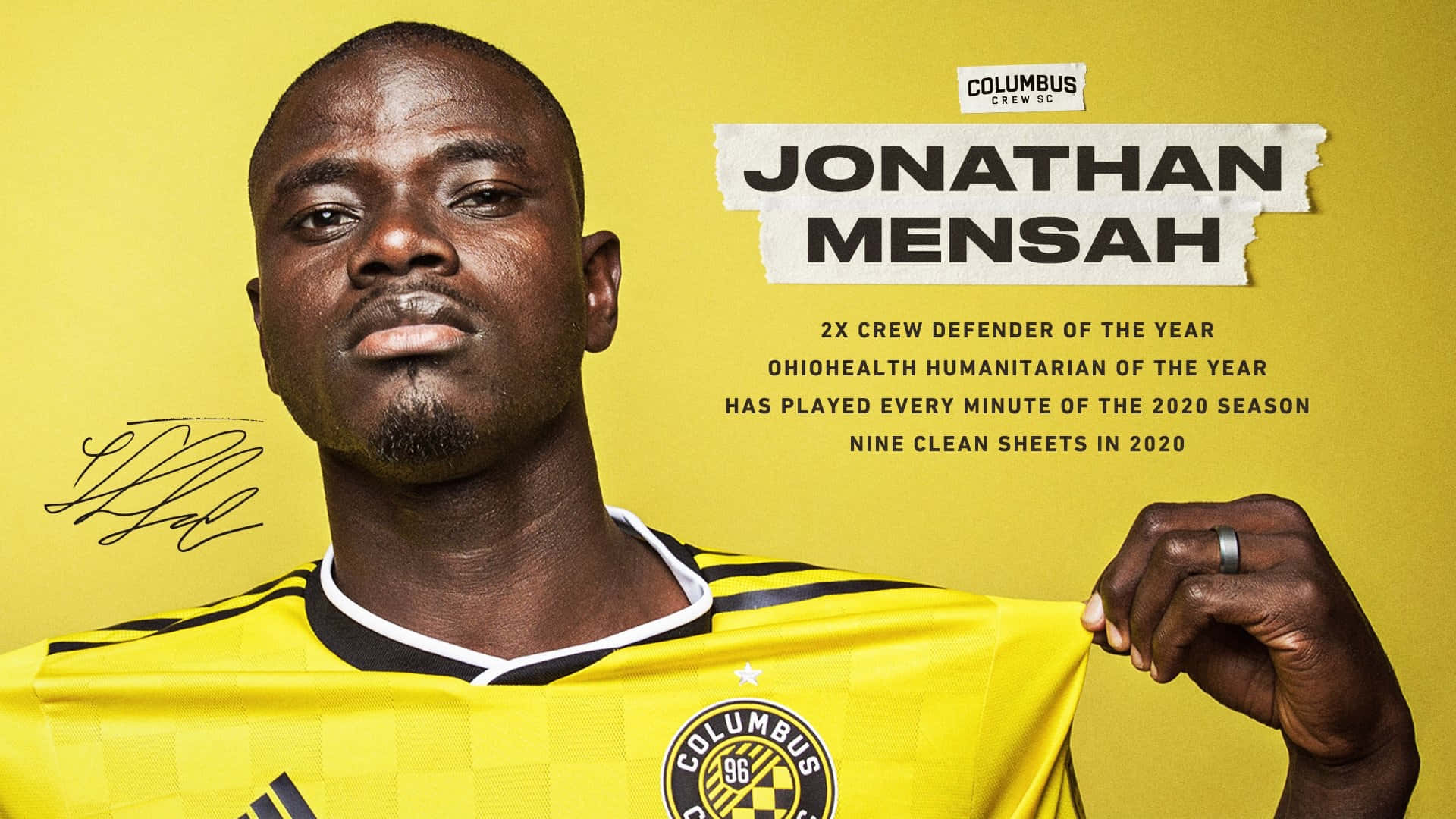 足球員 Jonathan Mensah 身穿黃色球衣，舉起帶有成就文字的球衣。