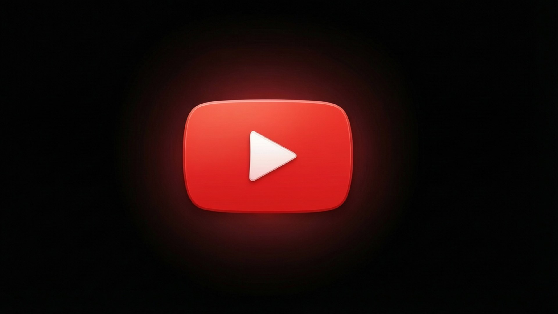 紅光播放按鈕 壁紙 — 一個發光的紅色 YouTube 播放按鈕圖示，置於深色背景中央，柔和光線向外擴散。