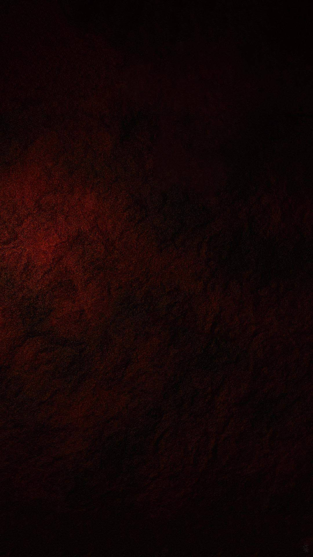 左側帶有發光紅光的深色紋理表面 — 主螢幕 壁紙