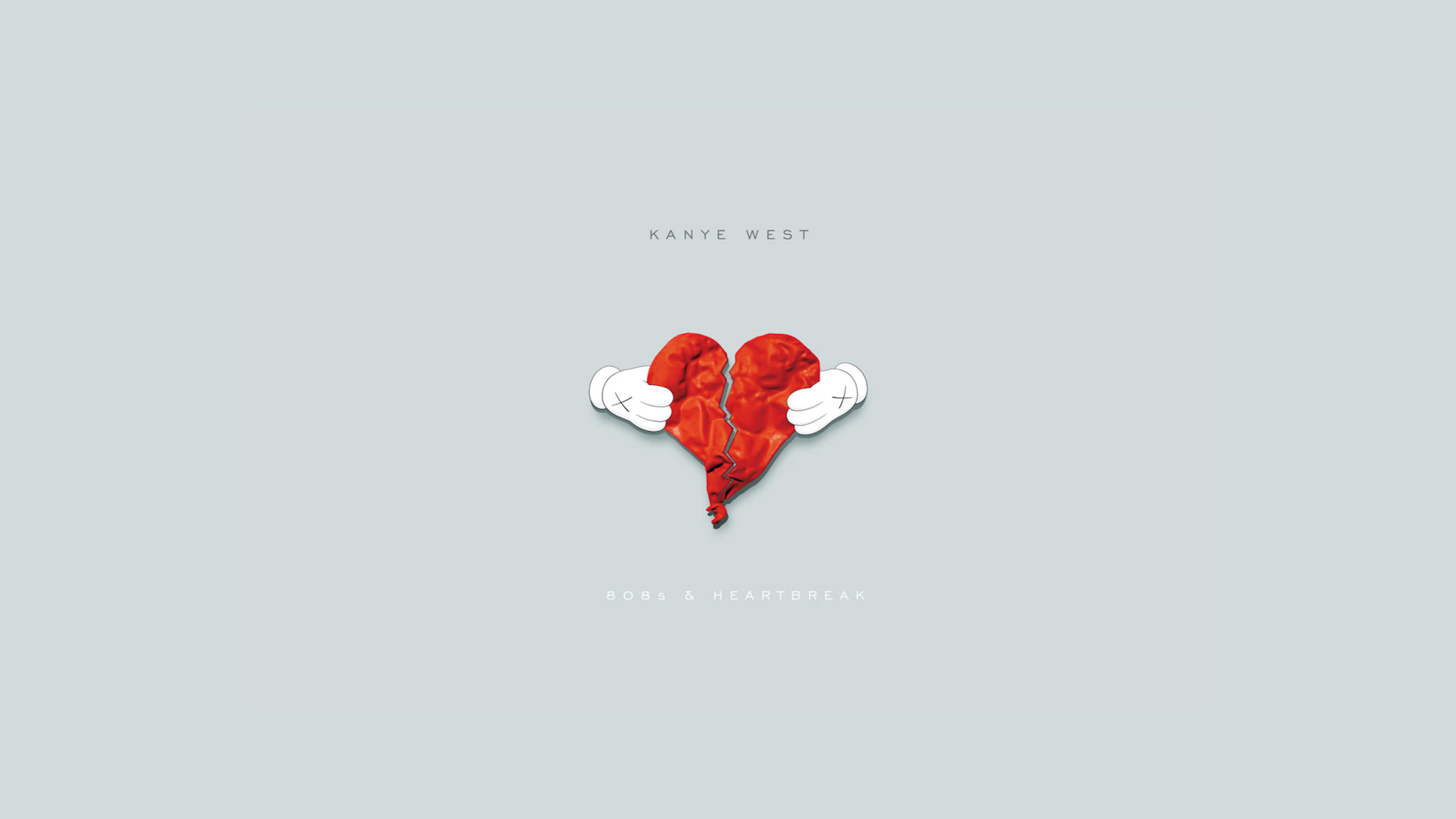 紅心與白心：Kanye West《808s and Heartbreak》專輯封面 壁紙 — 一個風格化的破碎紅心，由兩隻戴白手套的手捧著，背景是淺灰色。