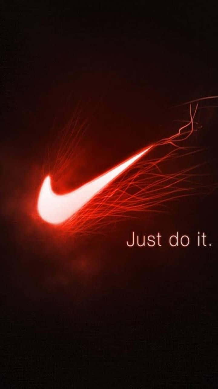 發光紅色Nike勾號，帶有「Just do it」口號，在黑暗背景上