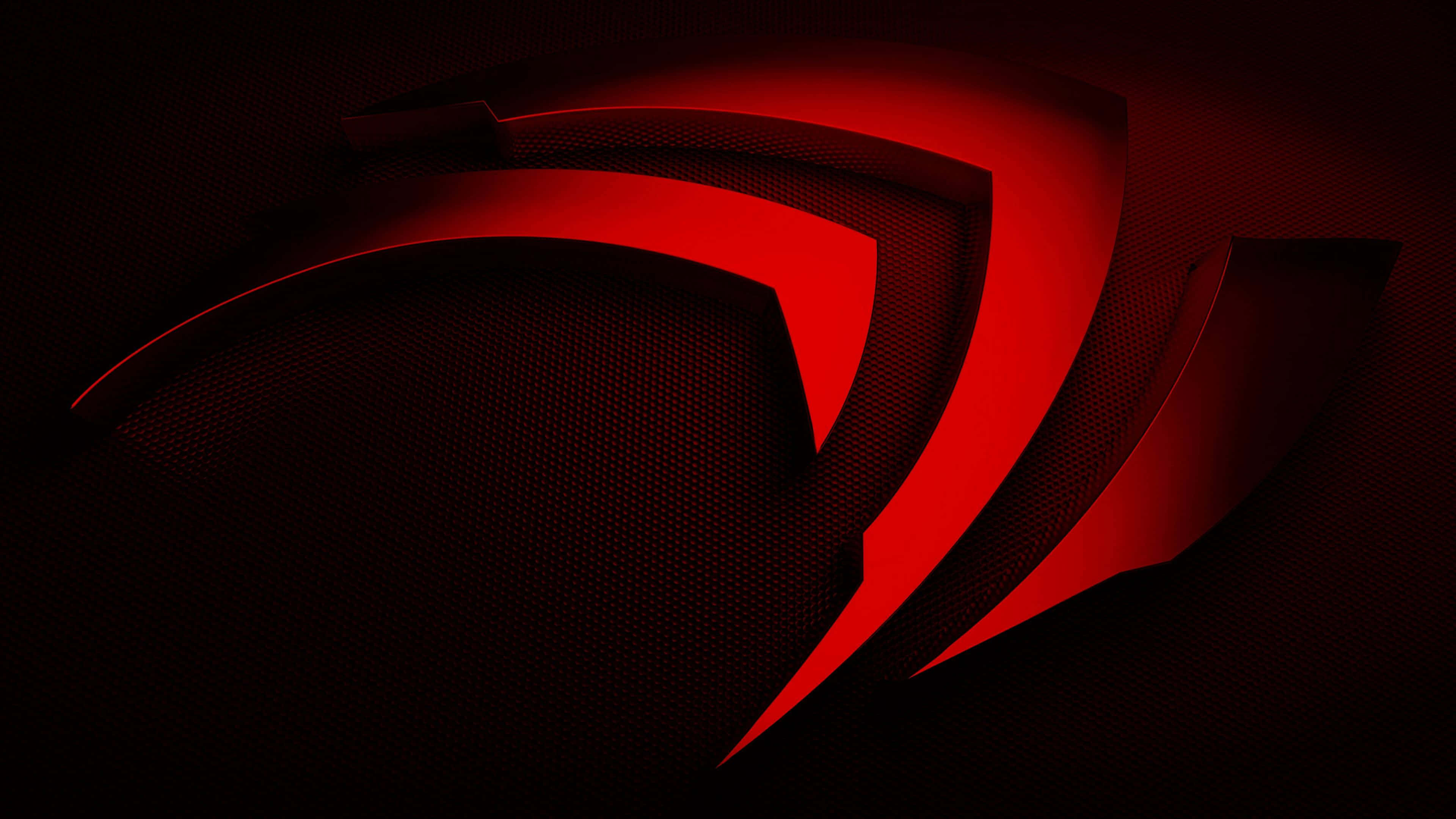 紅色NVIDIA 4K UHD標誌 壁紙 — 一個大膽的紅色棱角標誌在帶有戲劇性燈光和銳利陰影的深色紋理背景上發光。