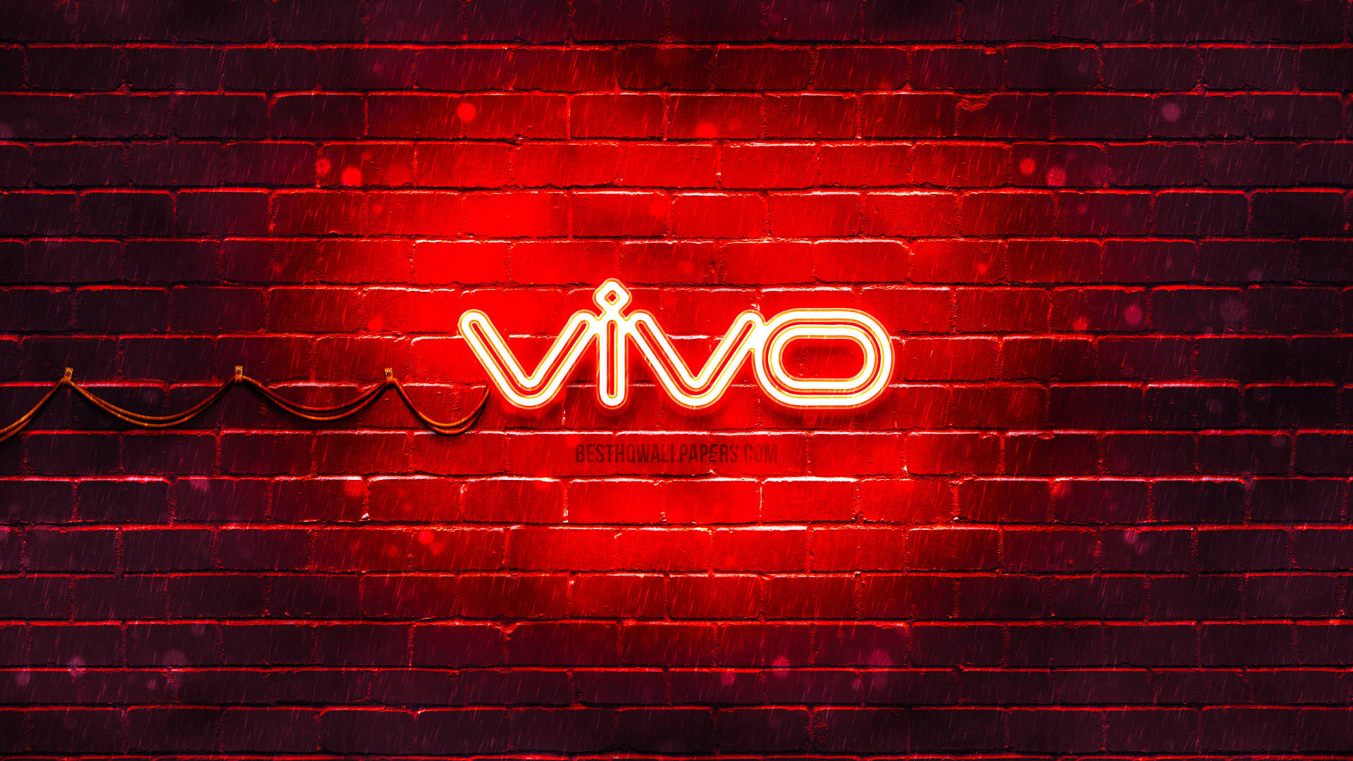 夜間潮濕磚牆上的紅色 vivo 霓虹燈招牌