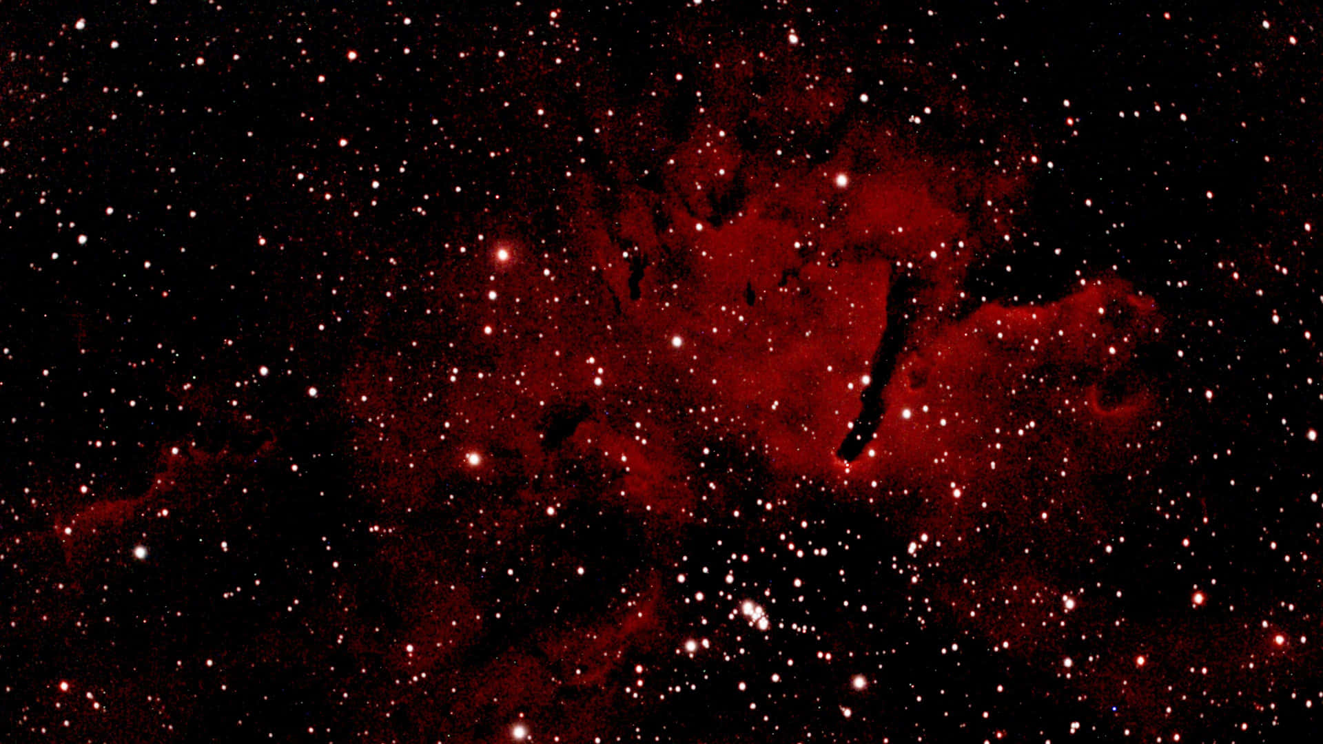 一個發出紅光的星雲，被深空中無數星星環繞。