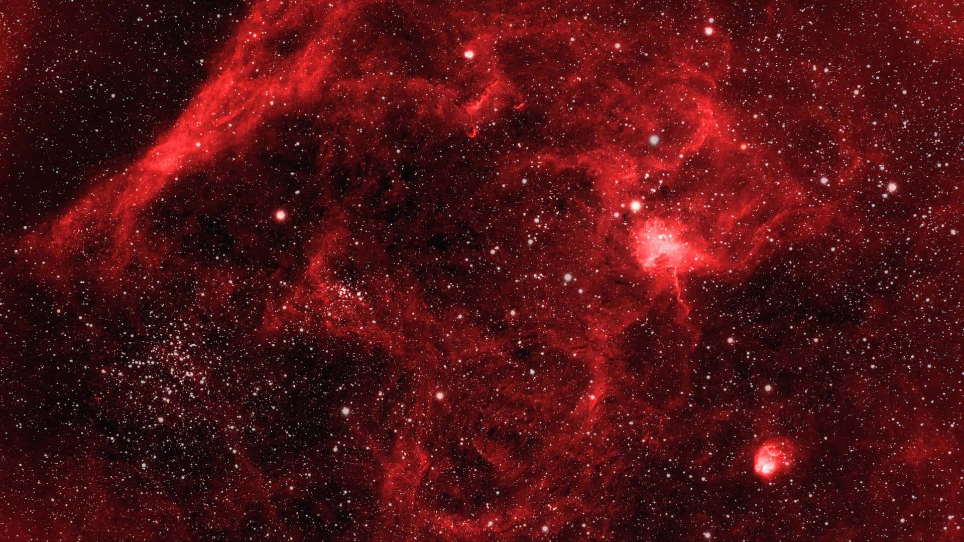 深空中充滿星星的紅色星雲。