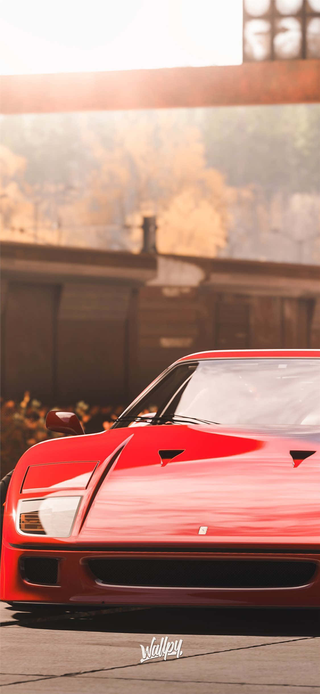 紅色法拉利 F40 靠近大型油罐 iPhone X Forza Motorsport 7 背景 壁紙 — 一輛鮮紅色的法拉利跑車在金色日落光線下閃閃發光，背景是質樸的工業環境。