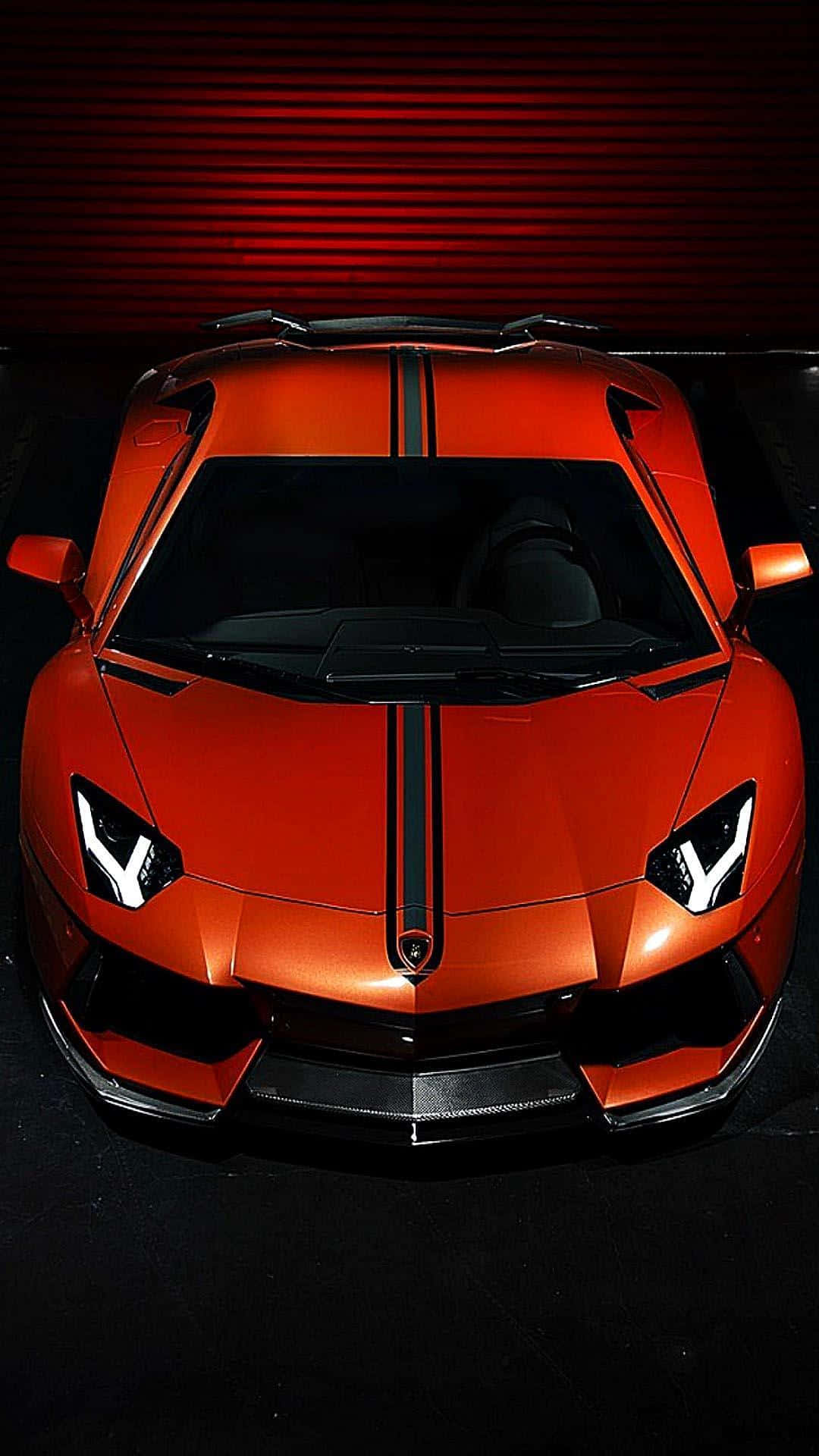 在工作室環境中帶有黑色條紋的橙色林寶堅尼跑車。