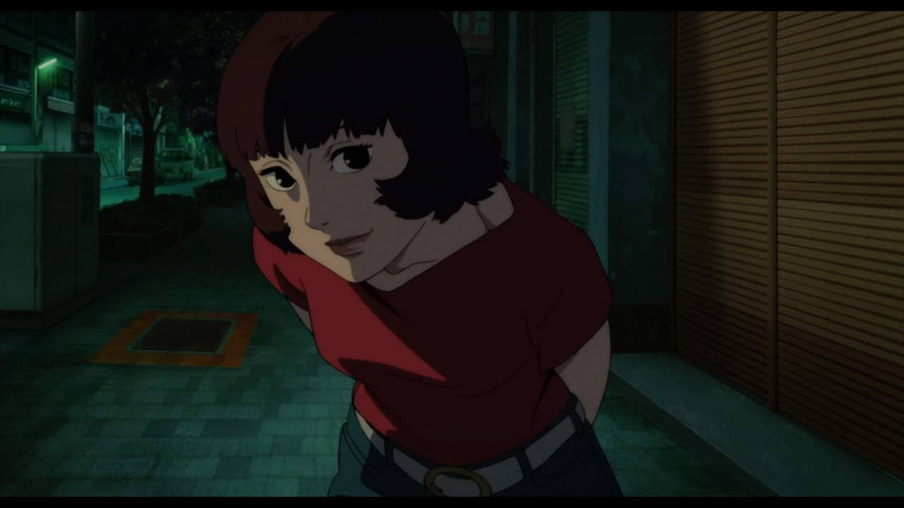 《紅辣椒》中的帕普里卡：細田守動畫電影女主角 壁紙 — 一位身穿紅色襯衫的年輕女子在夜晚昏暗的城市小巷中靠著建築物。