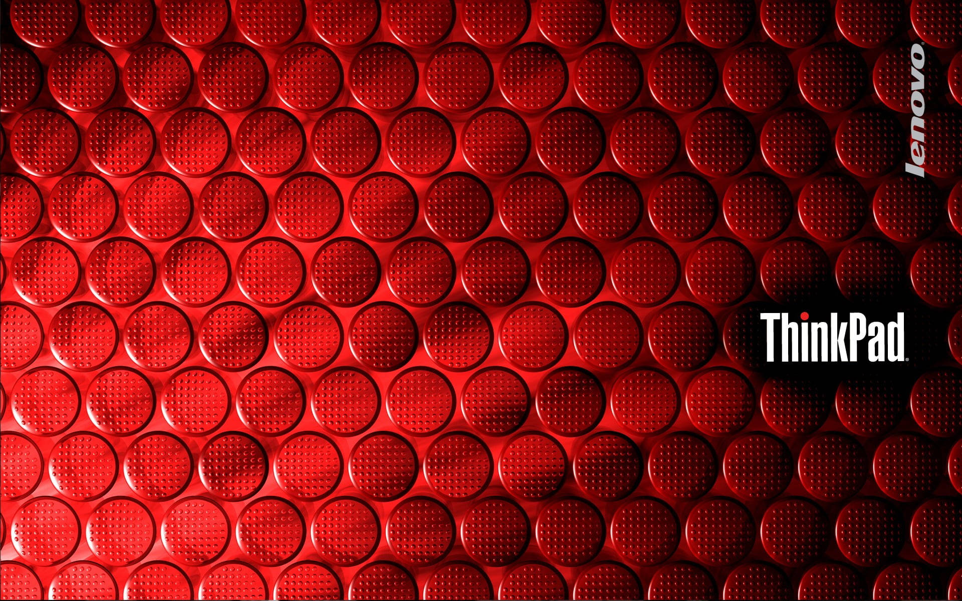 帶有圓形點和 Lenovo ThinkPad 標誌的紅色紋理壁紙。