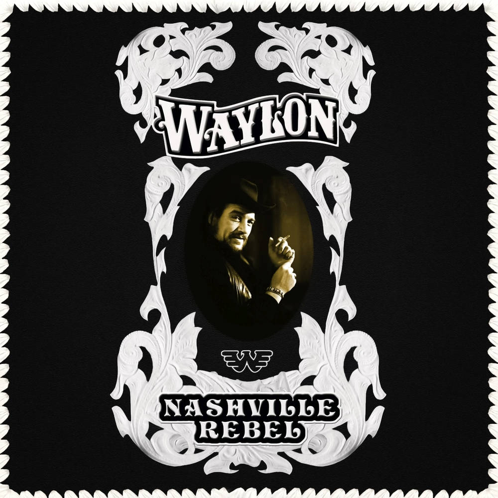 納什維爾叛逆者——韋蘭·金尼恩斯 壁紙 — Waylon Jennings 的復古風格肖像，以華麗的白色捲曲花紋鑲嵌在黑色背景上，並帶有 'Nashville Rebel' 文字。