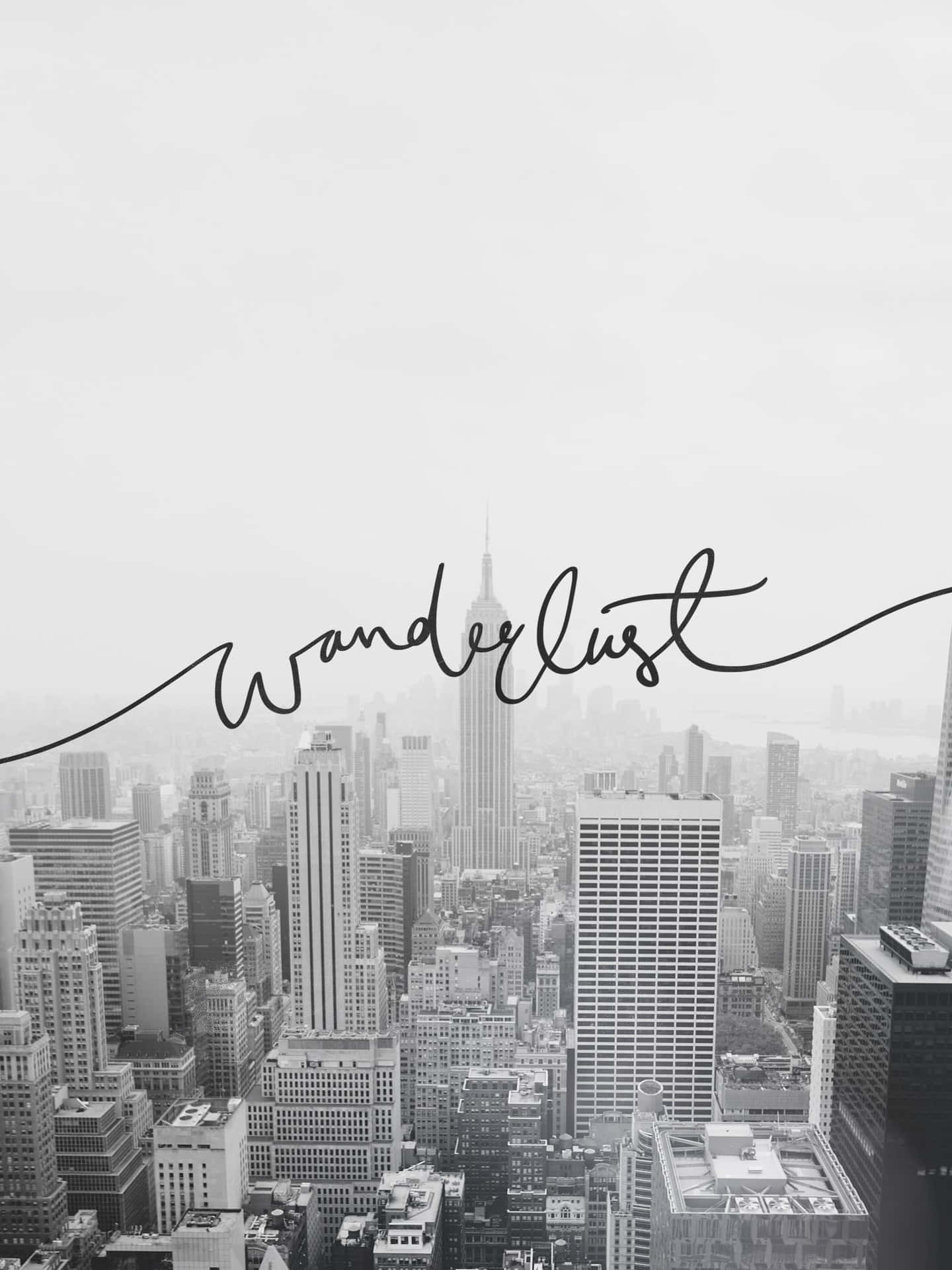 黑白城市景觀，覆蓋草書文字 'wanderlust'。