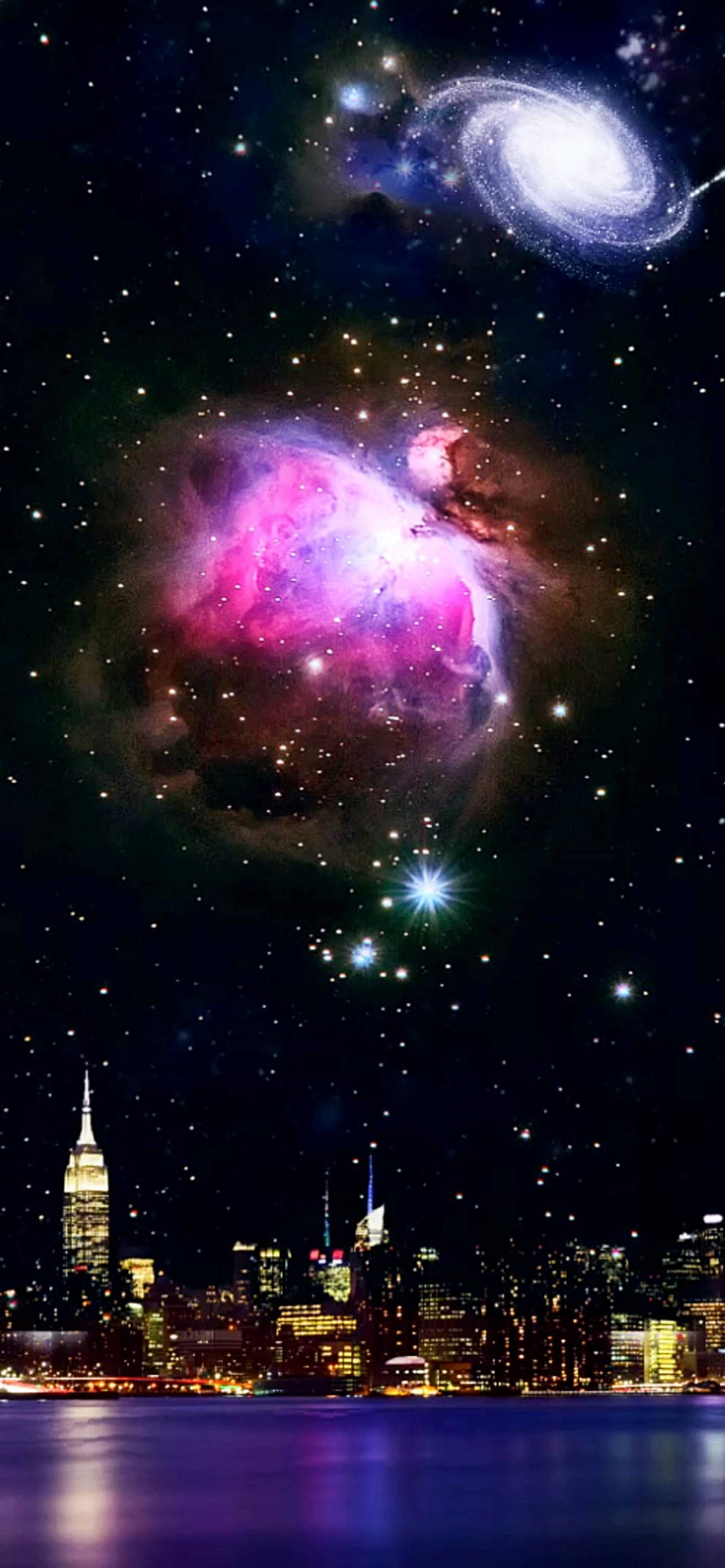 紐約市上空的宇宙 壁紙 — 一個充滿活力的宇宙星雲和螺旋星系懸浮在夜間發光的城市天際線之上。