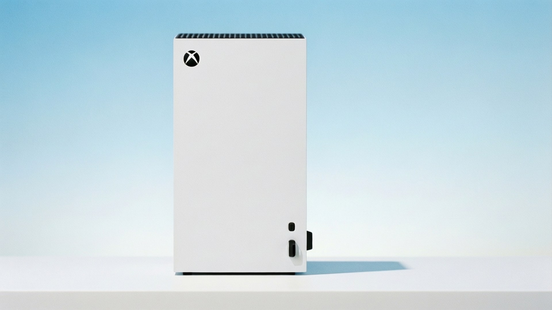 白色Xbox主機置於白色表面，配藍色漸變背景