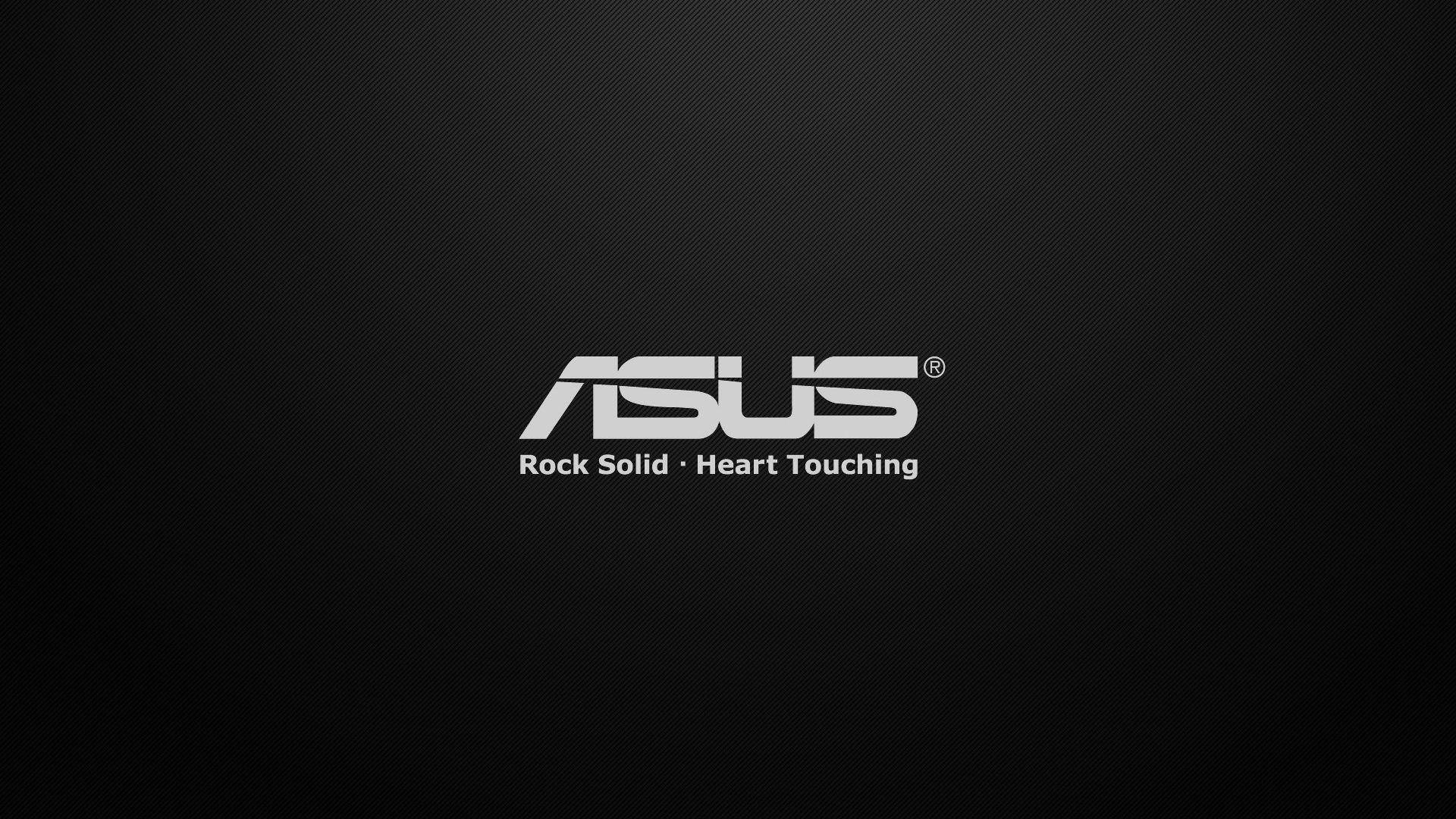 ASUS 品牌標誌附有標語 rock solid heart touching，置於深色紋理背景上。