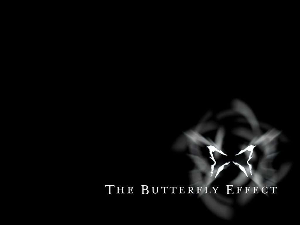 帶動態模糊的白色蝴蝶標誌，黑色背景上寫有文字 The Butterfly Effect。 — 唯美蝴蝶動圖 壁紙