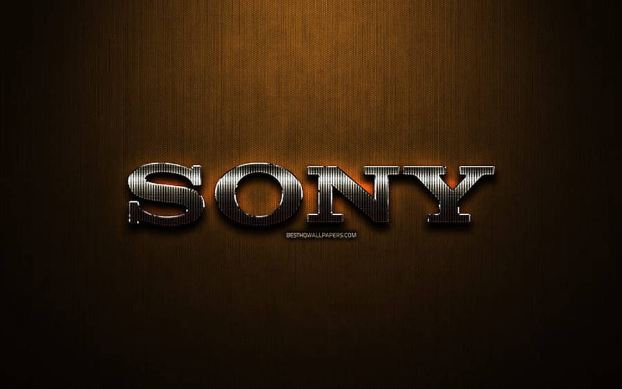 索尼標誌橙色漸層背景 壁紙 — Sony 標誌在溫暖的漸變背景上，帶有微妙的燈光效果，呈現金屬質感的光澤。