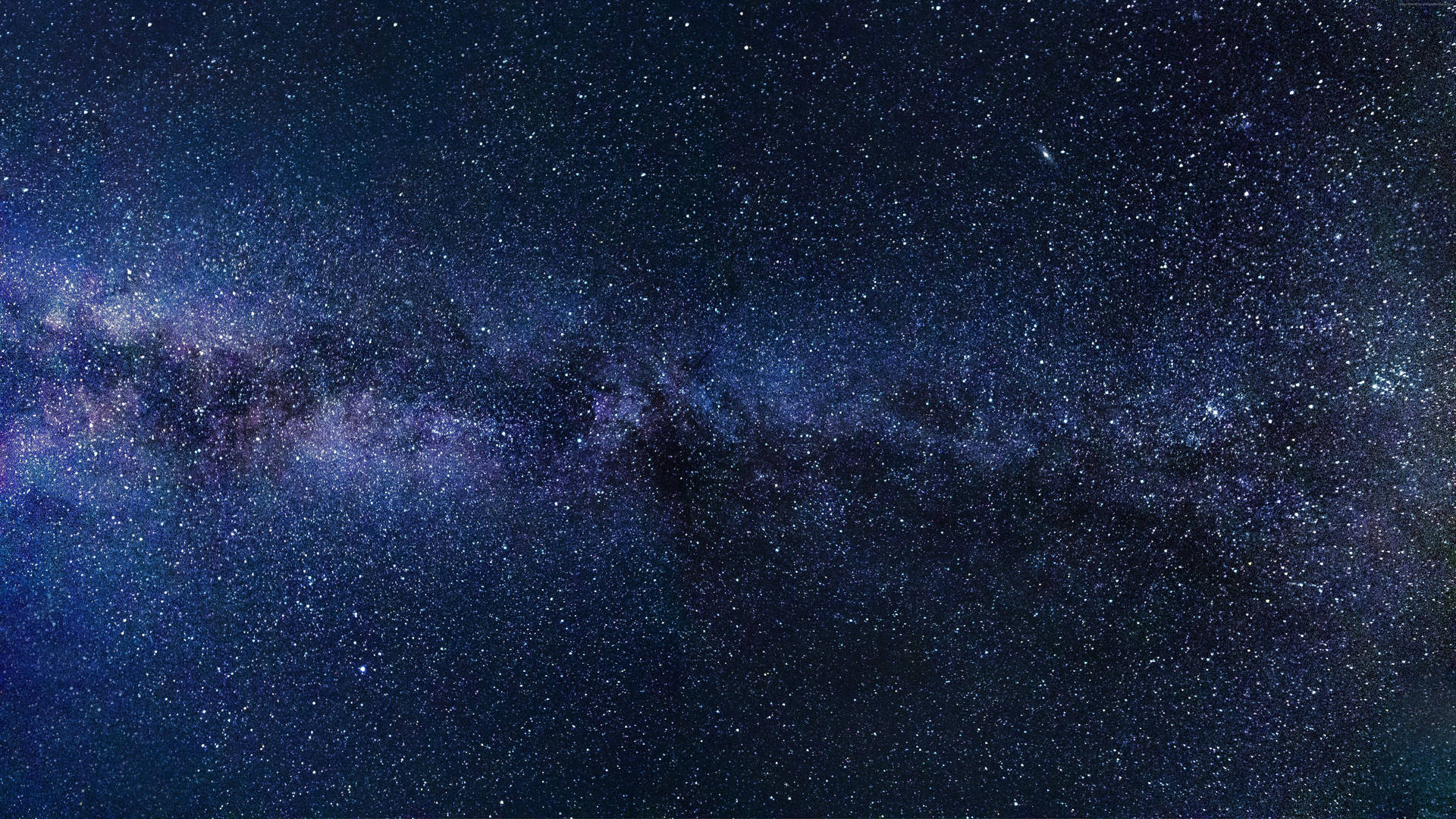 銀河系在黑暗的夜空中閃爍著紫色和藍色的星星。