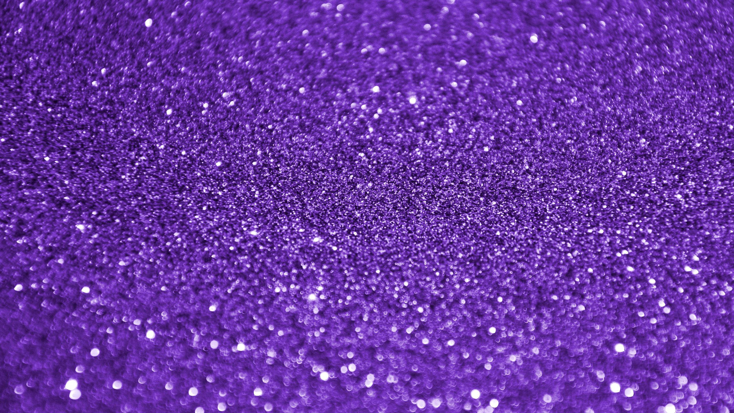 紫色虹彩閃粉背景 壁紙 — 近距離拍攝充滿活力的紫色閃粉，帶有閃爍的白色顆粒捕捉光線。
