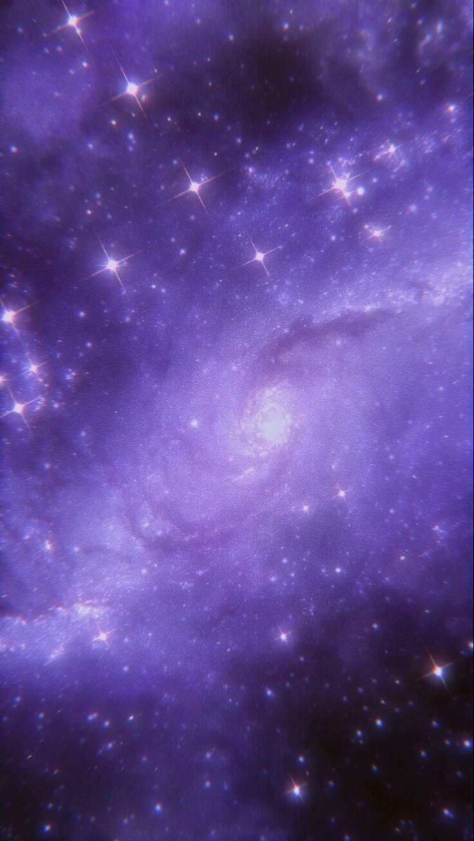 帶有明亮星星和宇宙塵埃雲的紫色螺旋星系。