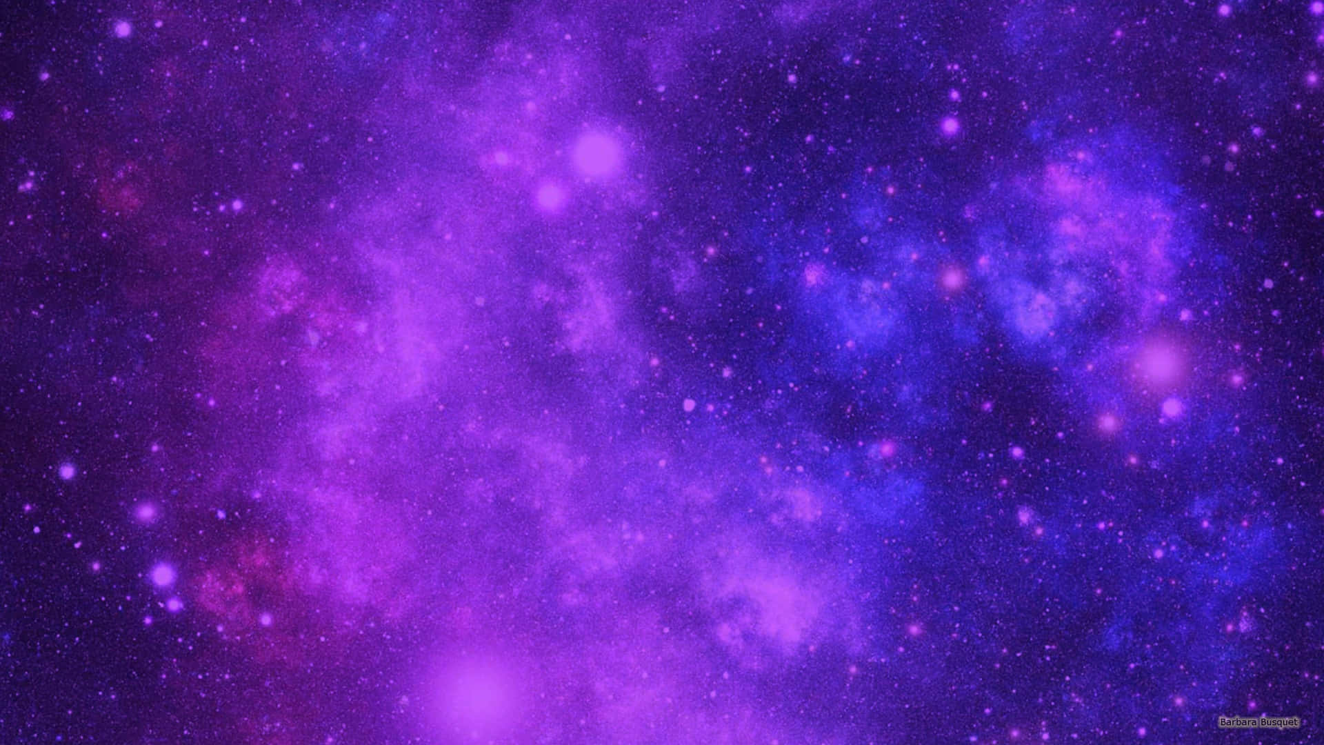 深空中充滿星星的鮮豔紫色和藍色星雲。