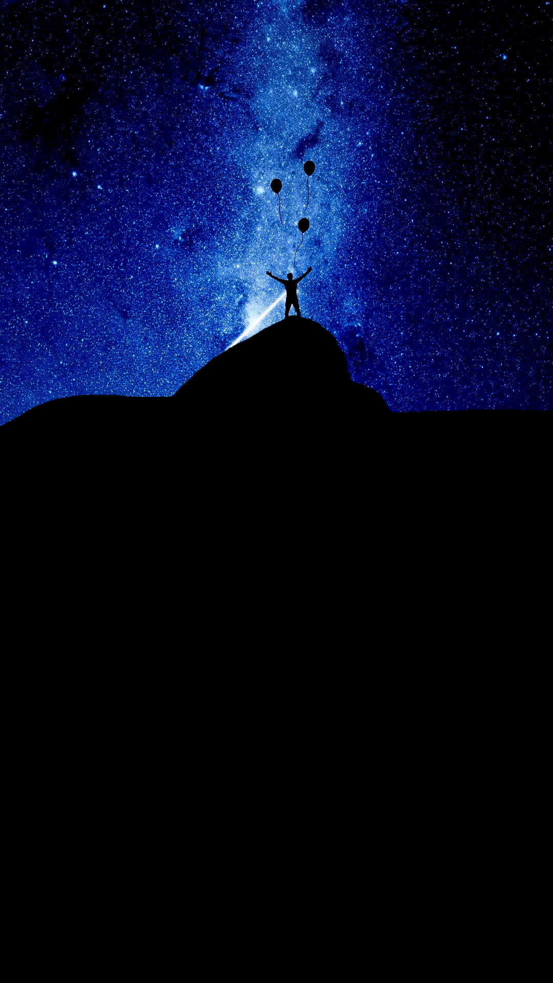 人在山頂上在星空下釋放氣球