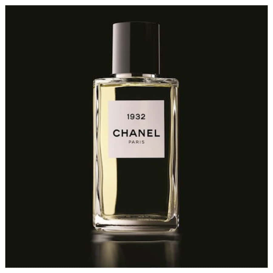 細節之美，盡顯香奈兒 壁紙 — 一個時尚的 Chanel 1932 香水瓶，內有金色液體，置於銳利的黑色背景中央，帶有柔和反射。