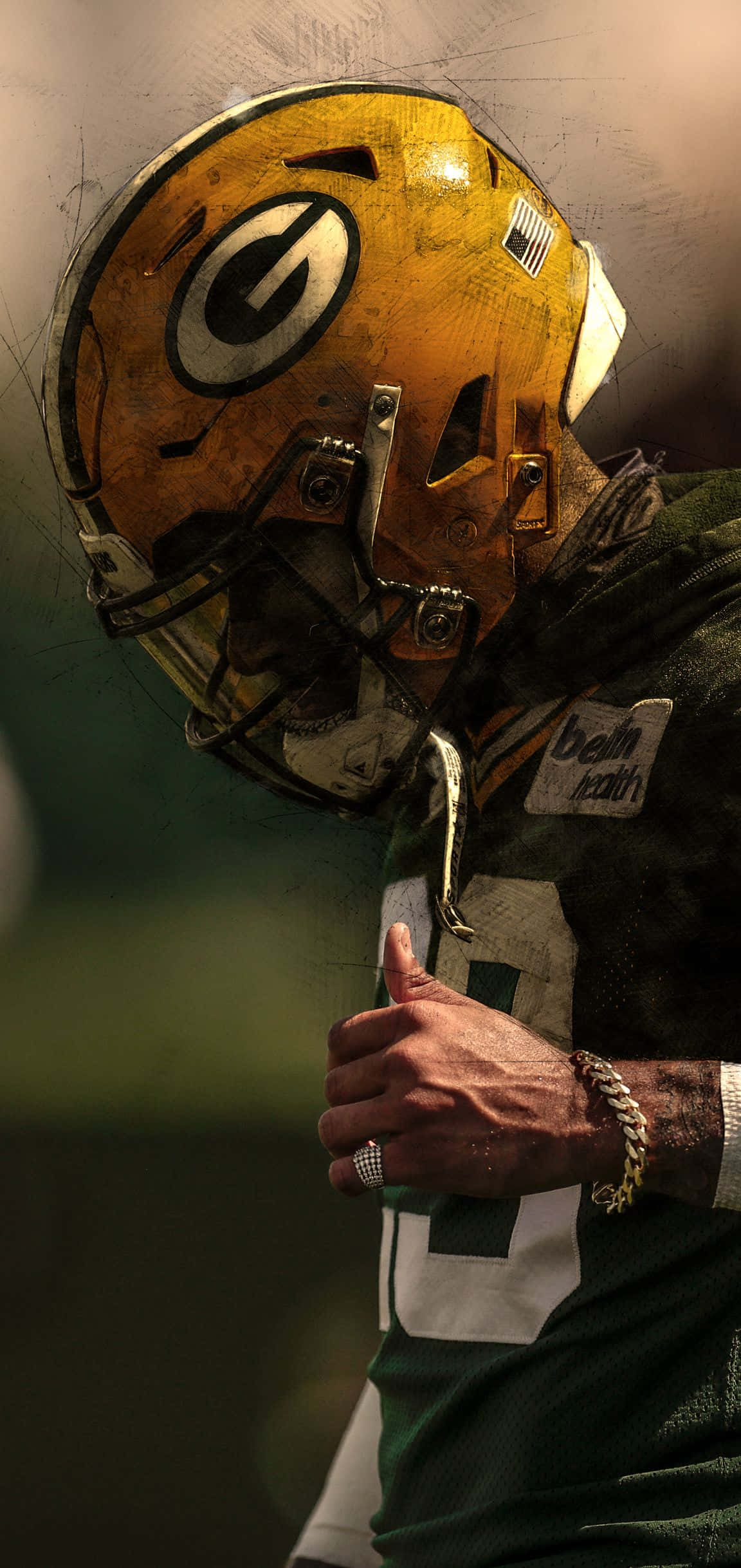 Packers 桌布 壁紙 — 綠灣包裝工美式足球員近距離特寫，戴著經風化的頭盔，豎起大拇指，表情堅定。