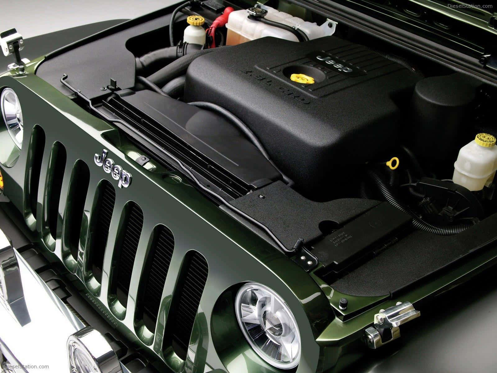 Jeep Gladiator 桌布 壁紙 — 綠色Jeep Wrangler引擎艙的特寫，展現複雜的機械部件和醒目的格柵設計。
