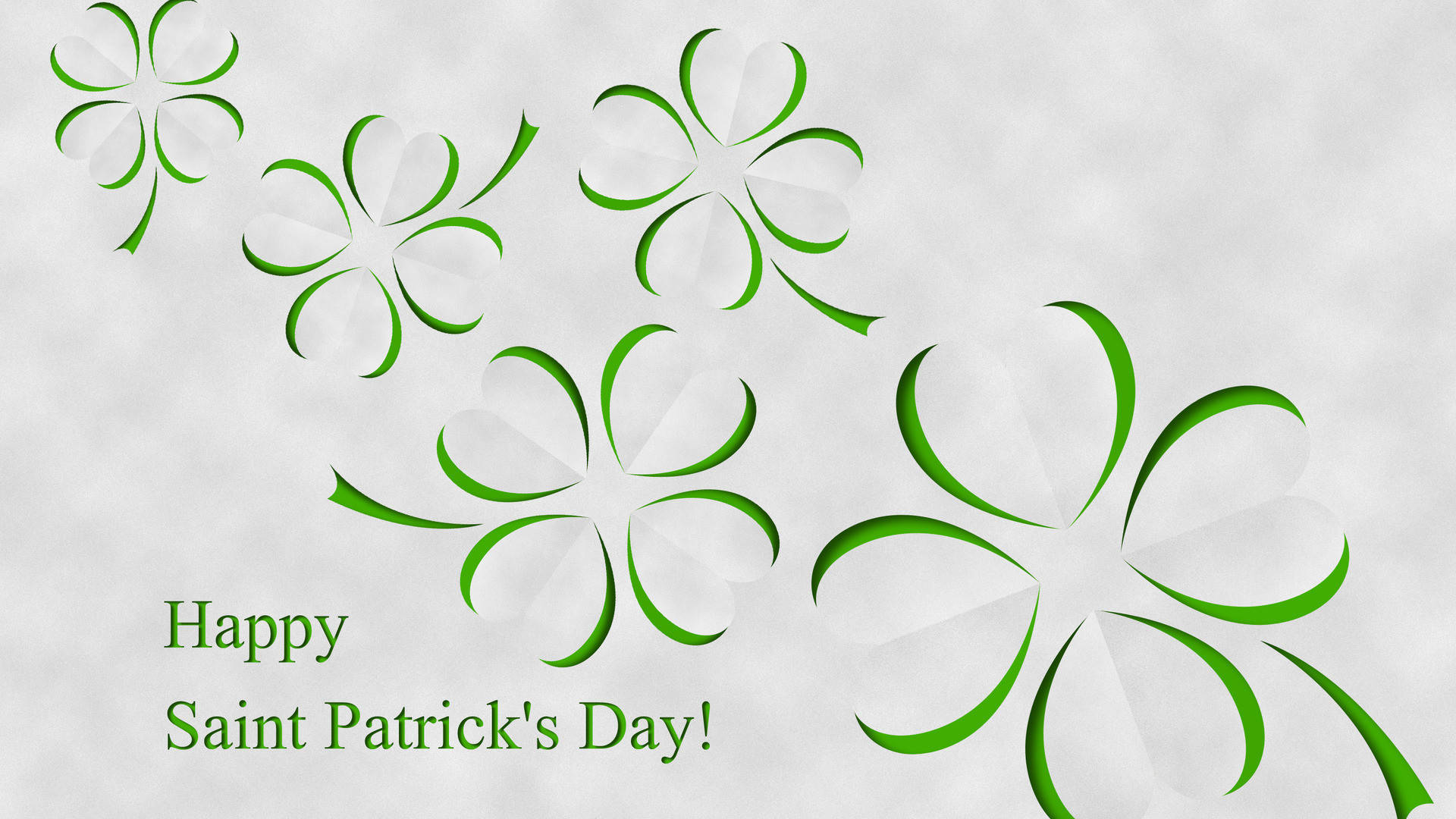 Saint Patricks Day 桌布 壁紙 — 綠色風格化的四葉草斜向漂浮在帶紋理的白色背景上，並帶有節日文字。