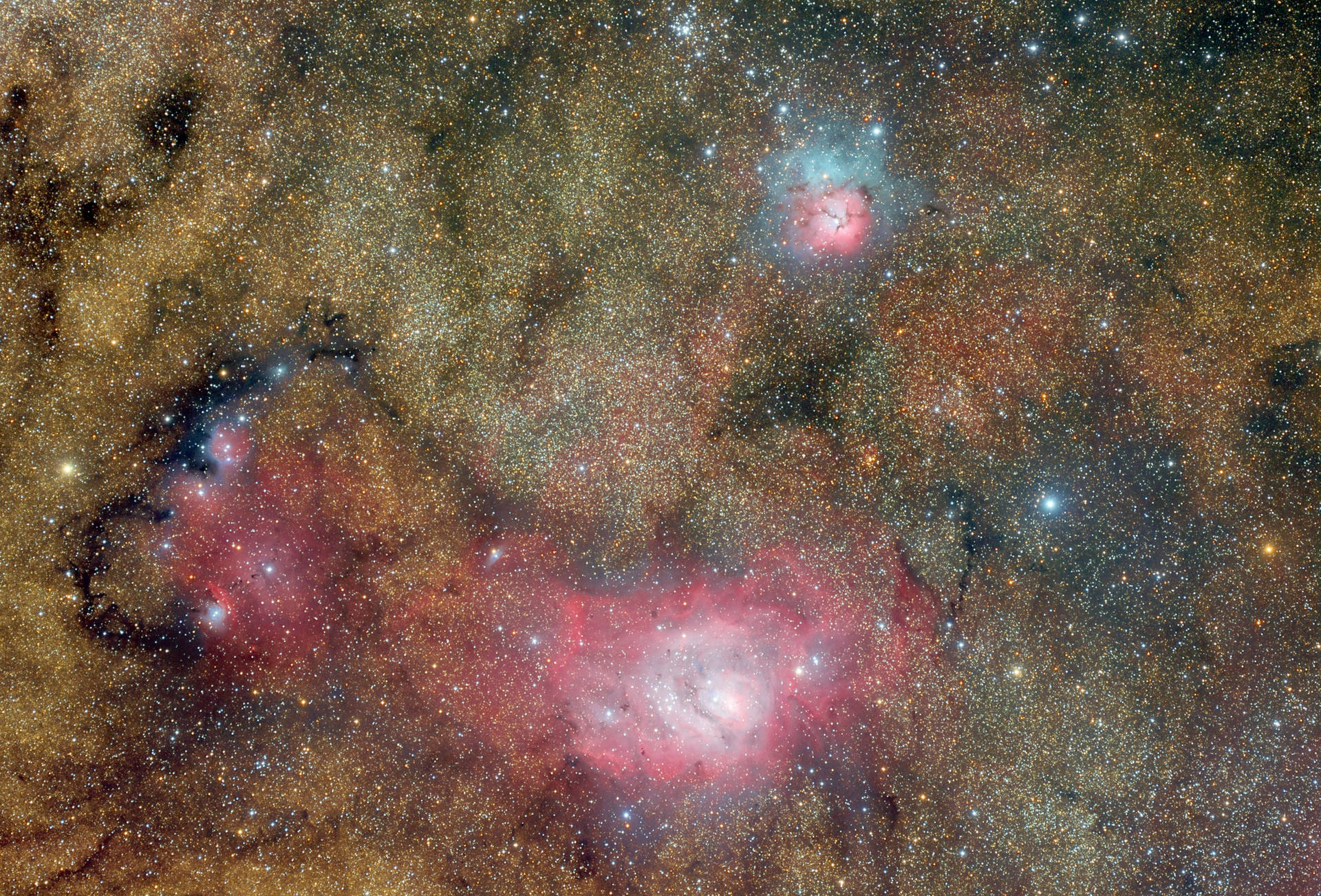 鮮豔的粉紅色和橙色星雲在佈滿星星的宇宙背景下發光。