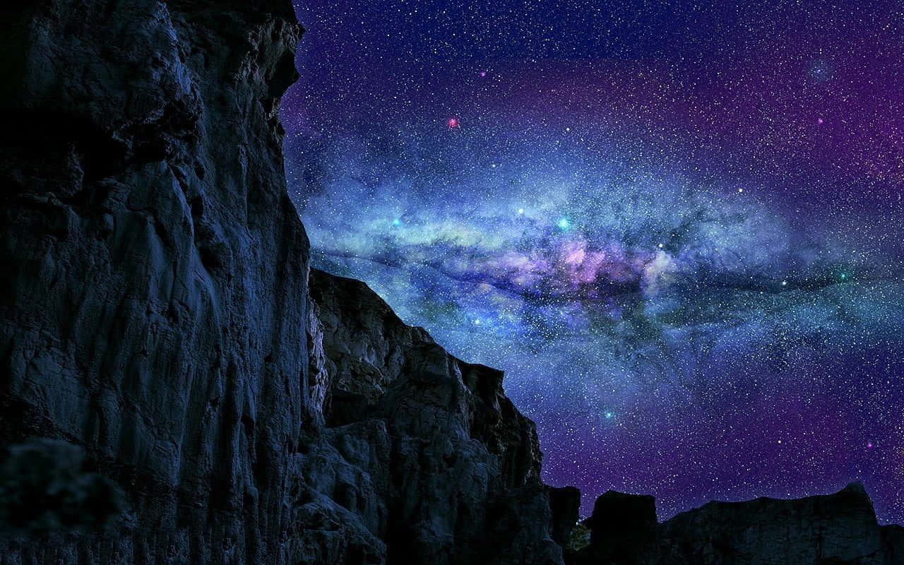 在充滿活力的繁星夜空下，黑暗的懸崖與發光的銀河。