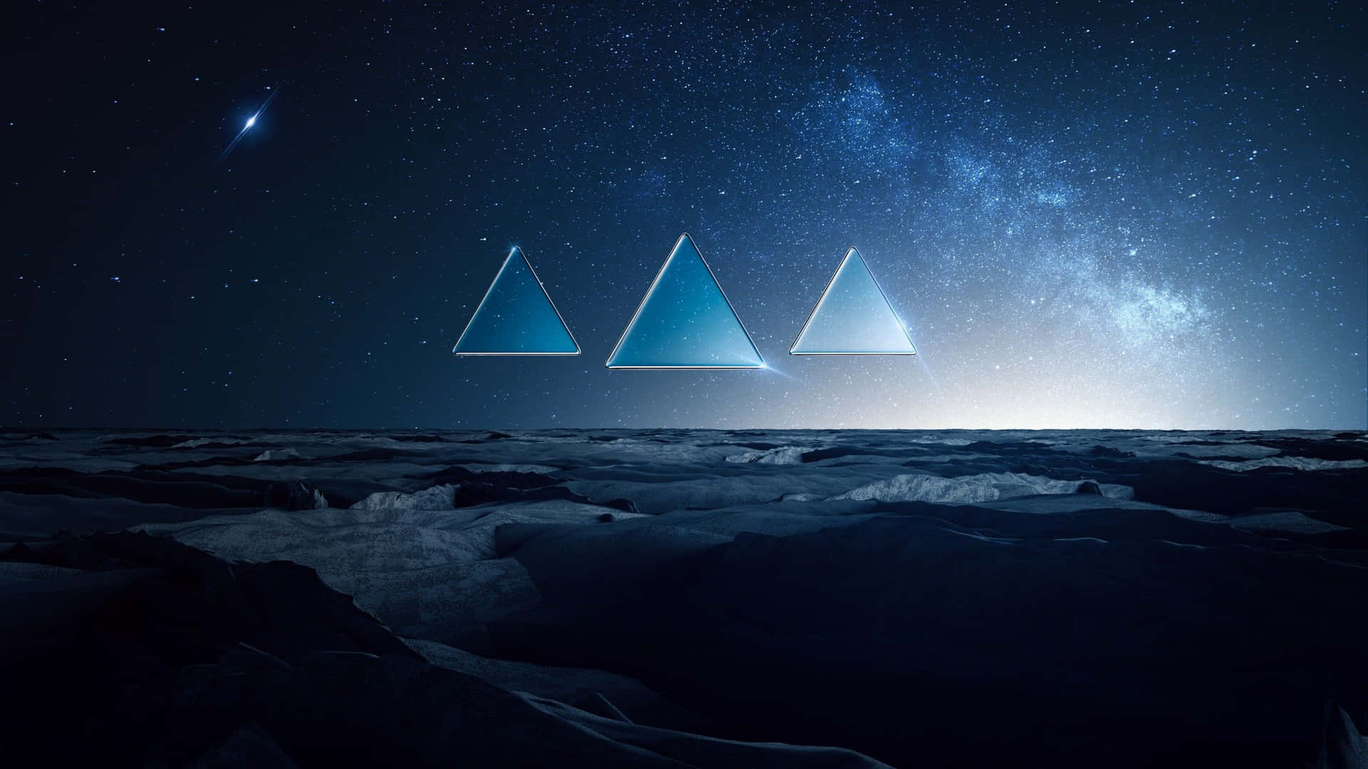 三個發光的藍色三角形漂浮在雪地上空，下方是繁星點點的夜空。