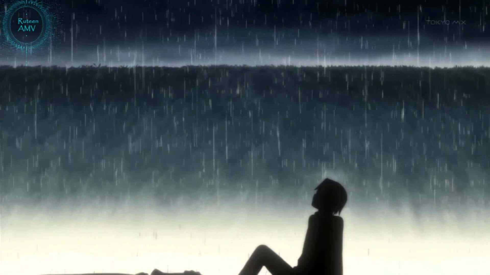 一個人在夜雨中獨自坐著的剪影。