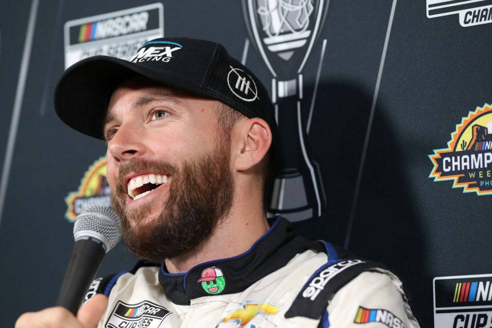 NASCAR車手在記者會上拿著麥克風微笑