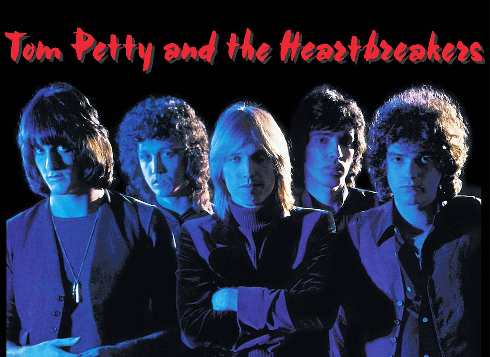 Tom Petty and the Heartbreakers 樂隊照片，帶有藍色燈光和紅色文字。