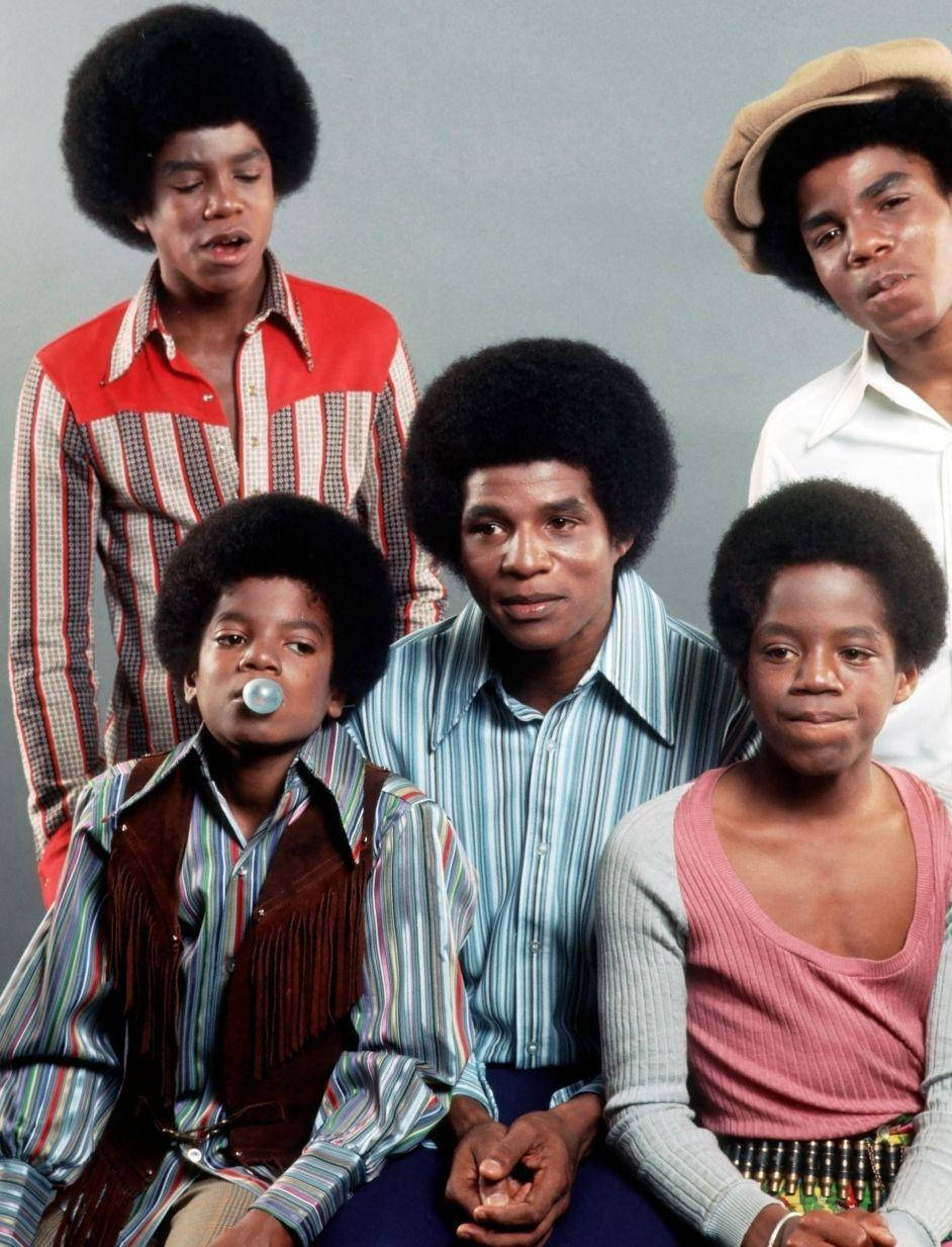 Jackson Five 穿著色彩繽紛的 1970 年代服裝在工作室肖像中擺姿勢。 — 米高積遜 GIF 壁紙