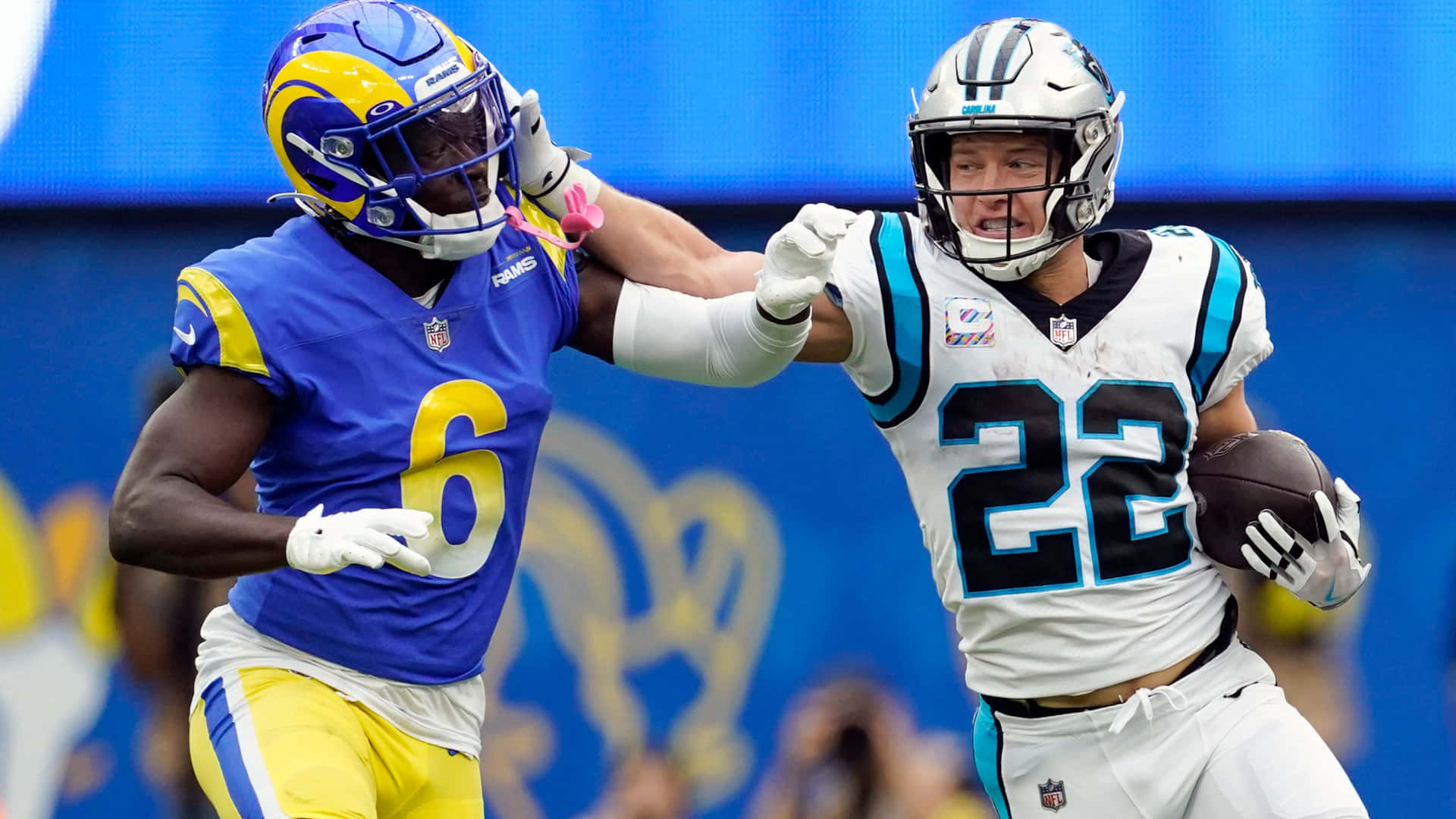 NFL美式足球球員在比賽中，一人擒抱另一持球者。