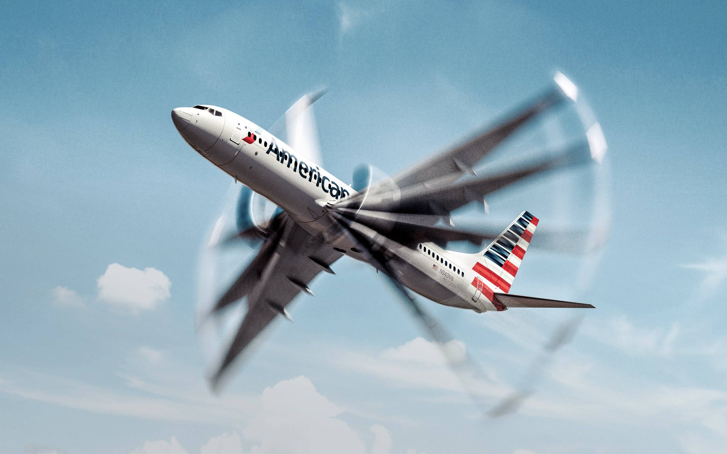 美國航空翼型翅膀 壁紙 — 一架美國航空噴射機在晴朗的藍天中翱翔，機翼因運動模糊而顯得模糊，背景是蓬鬆的白雲。